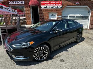 <p>Super-Clean Ford Fusion from Toronto, ON! This SE AWD model looks very sharp with its Black paint and dark factory-machined alloy wheels, with great options inside and out! The exterior features keyless entry with remote start and proximity keys, a factory power sunroof, automatic headlights, foglights, integrated mirror turn signals, a peppy 2.0L 4-cylinder turbocharged motor, and automatic transmission. The interior is comfortable and spacious with heated front leather power-adjustable seats with driver lumbar support, power door locks, windows and mirrors with drivers memory seating, a leather-wrapped steering wheel with audio and cruise controls, push-button start, an easy-to-read and use customizable gauge cluster, a large central touch screen AM/FM/XM satellite radio with Bluetooth Audio, Navigation, Climate settings, Rearview camera and APPS screen, Dual-Zone A/C climate control with front and rear window defrost settings, sleek gearshift system, universal garage door opener, USB/12V accessory ports and more!</p><p> </p><p>Carfax Claims Free, Great KM!</p><p> </p><p>Call (905) 623-2906</p><p> </p><p>Text Ryan: (905) 429-9680 or Email: ryan@markrainford.ca</p><p> </p><p>Text Mark: (905) 431-0966 or Email: mark@markrainford.ca</p>