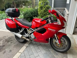 <p>2005 Ducati ST3</p><p>3 owner Ontario bike from new.</p><p>Service records including recent belt service and new tires.</p><p>Has rear Givi top case <span id=jodit-selection_marker_1713967062633_44210873296232767 data-jodit-selection_marker=start style=line-height: 0; display: none;></span>, upgraded Ohlins rear shock, Oxford heated grips, manual cruise control, upgraded windshield.</p><p>This bike is spotless.</p> <p>** Appointments are mandatory as most of our inventory is stored off site ** Unless stated otherwise all our vehicles come Ontario Safety Certified with a 30 day Dealer guarantee as well as a complimentary Carfax report. There are no hidden fees. Competitive financing rates are available for most of our vehicles and extended warranties are also available through Lubrico Canada. You can find us at 12993 Steeles Avenue, Halton Hills, just west of Trafalgar Road near the Toronto Premium Outlet Mall. Located beside Mississauga, we are easily accessed from the Trafalgar Road exit of Hwy 401. We have been proudly serving the GTA area including Milton, Georgetown, Halton Hills, Acton, Erin, Brampton Mississauga, Toronto, and the surrounding areas for over 20 years. Please visit or website at www.bulletproofauto.ca for videos of our inventory. If we dont have exactly what youre looking for, we will find it. Also please take the time to research our Google and Facebook reviews. We pride ourselves in exceptional customer service and will always strive to provide our customers with a unique and personal car buying experience.  Bulletproof Auto Sales. Aim Higher.<span id=jodit-selection_marker_1682346445326_9978056229470107 data-jodit-selection_marker=start style=line-height: 0; display: none;></span></p>