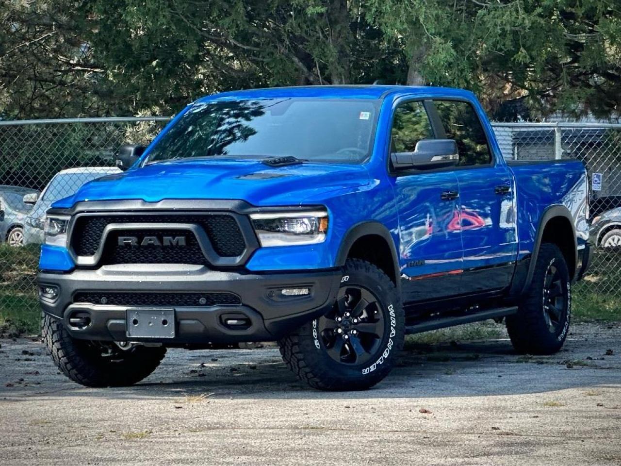 **PLEASE NOTE: Additional charges of $998 and $799 will be applied for Dealer-Installed running boards and LineX Bed Liner.**  Our New 2024 RAM 1500 Rebel Crew Cab 4X4 with the Level 2 Equipment Pack, G/T Pack, and Night Edition is an aggressive adventure machine that defies the ordinary in Hydro Blue Pearl w/ Diamond Black Crystal Pearl Two-Tone! Powered by a 5.7 Litre eTorque HEMI V8 supplying 395hp to an 8 Speed Automatic transmission for trail-friendly travels. This Four Wheel Drive truck also features versatile capability with a raised ride height, an electronic locking rear axle, robust skid plates, and a Class III bumper hitch, and it sees approximately 10.7L/100km on the highway. Our RAM shows its rebellious nature with LED lighting, fog lamps, a powder-coated front bumper, a sport performance hood, lower two-tone paint, alloy wheels, off-road fender flares, dual-panel sunroof, hitch receiver, and our Level 2 Pack for multifunction mirrors.  Rewarding features in our Rebel cabin come from our Level 2 Pack, which adds heated front seats, a heated premium steering wheel, power-adjustable pedals, a power rear window, 19-speaker Harman Kardon audio, remote start, and a 12-inch touchscreen. It complements standard features such as dual-zone automatic climate control, a 12.3-inch driver display, full-color navigation, WiFi compatibility, Android Auto®/Apple CarPlay®, Bluetooth®, and voice control.  RAM helps seal the deal with intelligent safety from forward collision warning, automatic braking, a rearview camera, hill start assistance, hill descent control, tire pressure monitoring, trailer sway damping, and more. With all that, our 1500 Rebel takes on tough challenges like a champ! Save this Page and Call for Availability. We Know You Will Enjoy Your Test Drive Towards Ownership!