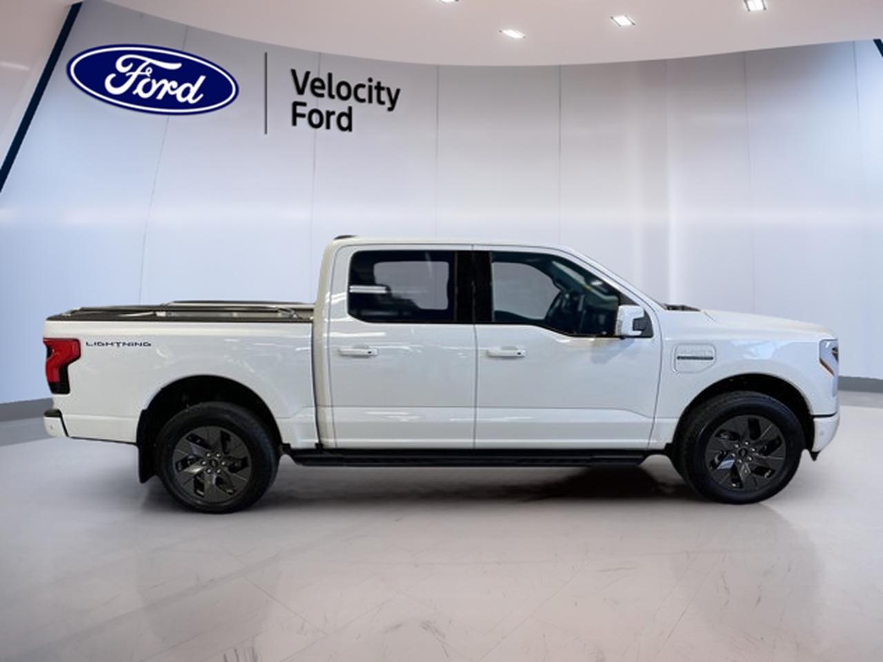 The 2023 Ford F-150 Lightning Pro 4WD SuperCrew 5.5 Box is a fully electric marvel, offering an impressive range and a robust towing capacity of 4,535 kg. With a sleek white exterior and a sophisticated black interior, this vehicle combines style with cutting-edge technology. CARFAX Canada confirms no accidents, ensuring peace of mind.

TRUCK FEATURES:
»» 4,535 kg towing capacity
»» 4 doors for easy access
»» Automatic transmission for smooth driving
»» 4-wheel drive for all-terrain capability

ELECTRIC VEHICLE FEATURES:
»» Fully electric with impressive range
»» Zero emissions for eco-friendly driving
»» Regenerative braking for energy efficiency
»» Quick charging capability

ADVANCED SAFETY FEATURES:
»» Comprehensive airbag system
»» Advanced traction control
»» Rearview camera for easy parking
»» Lane-keeping assistance

PERFORMANCE AND EFFICIENCY:
»» Electric engine with powerful performance
»» Automatic transmission for seamless driving
»» 12,829 km on the odometer
»» Energy-efficient design

COMFORT AND CONVENIENCE:
»» Spacious SuperCrew cab
»» Climate control for personalized comfort
»» Ample legroom for all passengers
»» Easy-to-use controls

TECHNOLOGY AND CONNECTIVITY:
»» Advanced infotainment system
»» Bluetooth connectivity for hands-free calls
»» High-resolution touchscreen display
»» USB ports for device charging

CARGO SPACE:
»» Spacious 5.5 box for cargo
»» Flexible storage options
»» Easy access tailgate
»» Ample room for all gear

WHAT OTHER OWNERS LIKE:
»» Impressive electric range
»» Robust towing capabilities
»» Advanced safety features
»» Comfortable and spacious interior

This 2023 Ford F-150 Lightning Pro 4WD SuperCrew 5.5 Boxs VIN is: 1FT6W1EV5PWG08252.