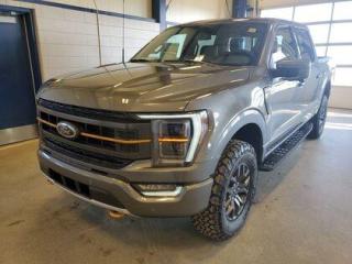 This all new 2023 Ford F-150 Tremor 402A is the highest trimline Tremor available and doesnt it look absolutely stunning in Carbonized Grey Metallic. This truck comes with the ever popular 3.5L EcoBoost engine. This remarkable engine not only produces 400 horsepower and 410 ft pounds of torque, but by leveraging the EcoBoost technology and a 10-speed automatic transmission this truck is rated it to get 13.3 L 100/km (25 miles per gallon) combined highway/city fuel economy. This 4-wheel drive truck also has an 10,900 lbs. towing capacity.

Key Features:
B&O Sound System 
12 Center-Stack LCD Screen
8 Productivity Screen in Instrument Cluster
Heated Front & Rear Seats
Heated Steering Wheel
18 Dark Matte Finish Alloy Wheels
360 Degree Camera
LED Projector Beam Headlamps
Power Tilt/Telescopic Steering Wheel W/Memory
Remote Start
Intelligent Cruise Control
Box link Cargo Management System W/Locking Cleats 
Apple Car Play/Android Auto 
FordPass Connect 
Dual-Zone Automatic Climate Control W/Automatic Temperature Control
4G Wi-Fi Modem
Universal Garage Door Opener 
10-Way Power Drivers Seat & Multi-Adjustable Passenger Seat
Automatic High Beam 
Wireless Charging pad
Reverse Brake Assist  
Lane Keeping System 
BLIS Pre-Collision Assist
Rain-Sensing Wipers
4X4

Saskatchewan has a rough climate, but the F150 Tremor is designed to shine out here. It leverages physical features and technology that will keep you comfortable and safe. This truck is loaded right up and includes 18 dark matte alloy wheels, 8 productivity screen in instrument cluster, BLIS w/trailer tow coverage,  rear under seat storage, AdvanceTrac with roll stability control, class 4 hitch w/4 & 7 pin wiring,  10-way power drivers seat, ambient lightning, wireless phone charging pad, power tilt/telescopic steering column with memory, power sliding rear window, intelligent cruise control, B&O sound system (8 speakers and a subwoofer), Ford Pass, Bluetooth,  lane-keeping alert, lane-keeping aid, dual-zone automatic climate control,  onboard 400W outlet, reverse brake assist, pre-collision braking, BLIS (blind spot information system), power adjustable pedals, remote start, remote tailgate release, remote start, automatic headlights, automatic high beam, reverse sensing system, LED fog lamps, lane keeping assist, rear view camera, post collision braking, trailer sway control, power tailgate lock, unique tremor control arms, unique tremor front knuckles, unique tremor style step bars, unique tremor box decals, 136L fuel tank, 3.73 locking rear axle, 9.75 gearset, electronic ten speed transmission and so much more. 

At Moose Jaw Ford, we're driving change all across Saskatchewan! We are Moose Jaw's prime destination for everything automotive. We pride ourselves by consistently providing the highest quality customer experience  every single time. Because of this commitment, and the love of what we do, Moose Jaw Ford is the recipient of multiple President's Club Awards and is recognized as one of Canada's Best Managed Companies. We are dedicated to building long lasting relationships. You can trust that our trained service technicians will take excellent care of you and your vehicle when you visit our service department. Come visit us today at 1010 North Service Road..