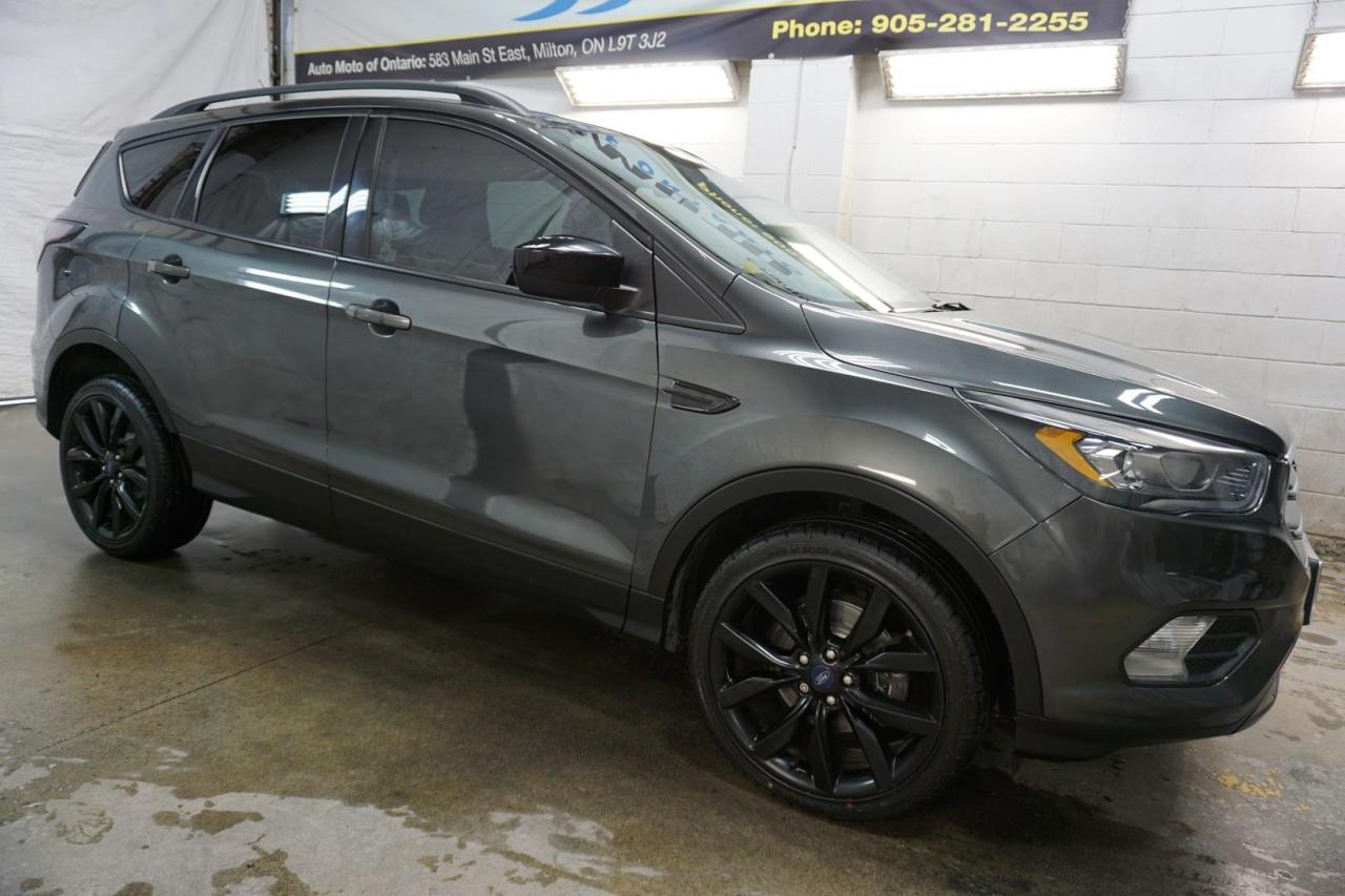 <div>*SERVICE RECORDS*LOCAL ONATRIO CAR*CERTIFIED<span>*</span><span> Very Clean Ford Escape SE 1.5L 4Cyl EcoBoost with Automatic Transmission has Heated Seats, Bluetooth and Cruise Control. Grey on Charcoal Interior. Fully Loaded with: Power Door Locks, Power Windows, and Power Mirrors, CD/AUX/USB, AC, Back Up Camera, Bluetooth, Push To Start, Alloys, Keyless Entry, Fog Lights, Heated Front Seats, Steering Mounted Controls, Cruise Control, Roof Rack, AND ALL THE POWER OPTIONS. </span></div><br /><div><span>Vehicle Comes With: Safety Certification, our vehicles qualify up to 4 years extended warranty, please speak to your sales representative for more details.</span></div><br /><div></div><br /><div></div><br /><div>Auto Moto Of Ontario @ 583 Main St E. , Milton, L9T3J2 ON. Please call for further details. Nine O Five-281-2255 ALL TRADE INS ARE WELCOMED!<o:p></o:p></div><br /><div><span>We are open Monday to Saturdays from 10am to 6pm, Sundays closed.</span></div><br /><div><span><br></span></div><br /><div><span><o:p></o:p></span></div><br /><div><a name=_Hlk529556975>Find our inventory at  www automotoinc ca</a></div>