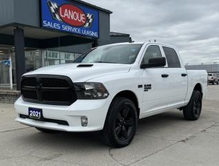 <p style=text-align: center;><strong><span style=font-size: 18pt;>2021 RAM 1500 CLASSIC EXPRESS 4X4 CREW CAB 57 BOX</span></strong></p><p style=text-align: center;><span style=font-size: 18pt;><span style=font-size: 24px;><strong>5.7L HEMI VVT V8 ENGINE WITH FUELSAVER MDS</strong></span></span></p><p style=text-align: center;><span style=font-size: 14pt;>395 HP @ 5,600 RPM / 410 LB-FT @ 3,950 RPM</span></p><p style=text-align: center;><span style=font-size: 14pt;>11.6L/100KM HIGHWAY / 16.2L/100KM COMBINED / 14.1L/100KM COMBINED</span></p><p style=text-align: center;><strong><span style=font-size: 14pt;>TOWING CAPACITY: 8,090 LBS / PAYLOAD: 1,720 LBS / GVWR: 6,800 LBS</span></strong></p><p style=text-align: center;><span style=font-size: 18pt;><span style=font-size: 24px;><strong>8–SPEED TORQUEFLITE AUTOMATIC TRANSMISSION</strong></span></span></p><p style=text-align: center;><span style=font-size: 18pt;><strong>20 SEMI-GLOSS BLACK ALUMINIUM WHEELS</strong></span></p><p style=text-align: center;> </p><p style=text-align: center;><span style=font-size: 14pt;><strong>STANDARD EQUIPMENT </strong></span></p><p style=text-align: center;><span style=font-size: 14pt;>Advanced multistage front air bags, Supplemental side curtain air bags, Supplemental side air bags, Supplemental front seat–mounted side air bags, ParkView Rear Back–Up Camera, 4–wheel anti–lock disc brakes, Electronic Stability Control, Tire pressure monitoring system, Automatic headlamps, 4–pin wiring harness, Engine block heater, 730–amp maintenance–free battery, 12–volt auxiliary power outlet, Air conditioning, Cruise control, Power windows with front 1–touch up and down, Hands–free communication with Bluetooth streaming</span></p><p style=text-align: center;> </p><p style=text-align: center;><span style=font-size: 14pt;><span style=font-size: 18.6667px;><strong>OPTIONAL EQUIPMENT</strong>  </span></span></p><p style=text-align: center;><span style=font-size: 14pt;><span style=font-size: 18.6667px;>Premium cloth front bucket seats, <em>Customer Preferred Package 26J:</em> Goodyear brand tires, Ram 1500 Express Group, Fog lamps, <em>Sub Zero Package: </em>Front heated seats, Flat load floor, 115–volt auxiliary power outlet, Power lumbar adjust, Power 10–way driver seat including 2–way lumbar                Security alarm, Heated steering wheel, Steering wheel–mounted audio controls, Leather–wrapped steering wheel, remote start system, <em>Electronics Convenience Group: </em>7-inch colour in-cluster display, <em>Night Edition package: </em>A/C with dual–zone automatic temperature control, Black headlamp bezels, Gloss Black grille, Google Android Auto, Apple CarPlay capable, </span></span><span style=font-size: 18.6667px;>8.4–inch touchscreen, </span><span style=font-size: 18.6667px;>SiriusXM satellite radio , Uconnect 4C with 8.4–inch display, 20x8–inch Semi–Gloss Black aluminum wheels, Semi–Gloss Black wheel centre hub, Humidity sensor, <em>Wheel & Sound Group:</em> Carpet floor covering, <em>8–speed TorqueFlite automatic transmission, 5.7L HEMI VVT V8 engine with FuelSaver MDS, Sport performance hood, Class IV hitch receiver</em></span></p>