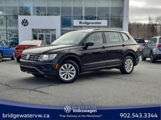 New Price! Black 2021 Volkswagen Tiguan Trendline 4Motion | APPLE CARPLAY | ANDROID AUTO | One Owner AWD 8-Speed Automatic with Tiptronic 2.0L TSI Bridgewater Volkswagen, Located in Bridgewater Nova Scotia.AWD, 3.33 Axle Ratio, 4-Wheel Disc Brakes, 6 Speakers, ABS brakes, Air Conditioning, Alloy wheels, AM/FM radio, App-Connect (Android Auto/Apple CarPlay/MirrorLink), Brake assist, Bumpers: body-colour, Cloth Seating Surfaces, Delay-off headlights, Driver door bin, Driver vanity mirror, Dual front impact airbags, Dual front side impact airbags, Electronic Stability Control, Exterior Parking Camera Rear, Four wheel independent suspension, Front anti-roll bar, Front Bucket Seats, Front reading lights, Fully automatic headlights, Heated door mirrors, Heated Front Bucket Seats, Heated front seats, Illuminated entry, Low tire pressure warning, Occupant sensing airbag, Outside temperature display, Overhead airbag, Overhead console, Panic alarm, Passenger door bin, Passenger vanity mirror, Power door mirrors, Power steering, Power windows, Radio data system, Radio: 6.5 Touchscreen Infotainment System, Rear anti-roll bar, Rear reading lights, Rear window defroster, Rear window wiper, Remote keyless entry, Roof rack: rails only, Speed control, Speed-sensing steering, Split folding rear seat, Spoiler, Standard Suspension, Steering wheel mounted audio controls, Tachometer, Telescoping steering wheel, Tilt steering wheel, Traction control, Trip computer, Turn signal indicator mirrors, Variably intermittent wipers.Volkswagen Certified Details:* Any remaining new-vehicle limited warranty. Certified Pre-Owned vehicles are eligible for extended warranty coverage, giving you greater peace of mind* Finance rates from 4.99%* A completed 112-point inspection plus mechanical and appearance reconditioning assessment performed by a Volkswagen factory-trained technician* Prepaid Maintenance is now available for Certified Pre-Owned Volkswagens. Lock in your maintenance fees by choosing between a 2- or 3-year plan. Vehicles up to 7 years of age are eligible for the purchase of our Prepaid Maintenance plans regardless of mileage. A 3-month SiriusXM all-access trial subscription / Recent college, CEGEP or university Graduates can get a $500 rebate / CARFAX Vehicle History Report* A 6-month subscription to Volkswagen 24-hour roadside assistanceReviews:* Owners and experts alike almost universally count the Tiguan?s ride quality, highway manners, interior, and overall easy-to-drive character among its most valuable assets. The central touchscreen infotainment system and all-digital instrument cluster are commonly listed as feature favourites, as they add a high-tech flair to the driving environment. Source: autoTRADER.ca