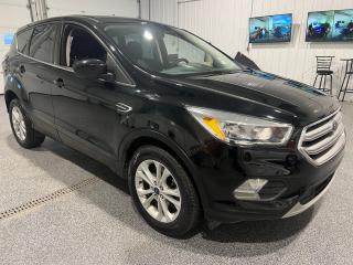 <div><b>Embark on an adventure with the 2017 Ford Escape SE 4WD, a robust and versatile SUV that combines the power of a 1.5L EcoBoost 4-cylinder engine with the convenience of a smooth 6-speed automatic transmission. The All-Wheel Drive system provides the extra grip and confidence you need to tackle various road conditions, making this vehicle a reliable choice for those who value performance and stability.</b></div><br /><div><b><br></b></div><br /><div><b>The exterior of the Escape SE is finished in a sleek Agate Black, complemented by stylish 17-inch alloy rims that not only contribute to the vehicles aesthetic appeal but also ensure a comfortable ride. The presence of a spoiler and fog lights enhance the SUVs sporty look while improving functionality.</b></div><br /><div><b><br></b></div><br /><div><b>Inside, youll find a Charcoal Black Cloth interior that exudes a sense of sophistication and cleanliness. The cabin offers a range of features designed to ensure a seamless driving experience:</b></div><br /><div><b><br></b></div><br /><div><b>- The 10-way power-adjustable drivers seat allows for optimal positioning and comfort, ensuring youre always in command.</b></div><br /><div><b>- Heated front seats provide warmth and relaxation during cooler weather.</b></div><br /><div><b>- Dual-zone electronic automatic temperature control lets occupants set their preferred climate, maintaining comfort throughout the cabin.</b></div><br /><div><b>- With remote keyless entry and the SecuriCode entry keypad, accessing your vehicle becomes both convenient and secure.</b></div><br /><div><b><br></b></div><br /><div><b>When it comes to technology and safety, the 2017 Ford Escape SE doesnt disappoint:</b></div><br /><div><b><br></b></div><br /><div><b>- Stay connected with the SYNC voice recognition communications and entertainment system, which includes a USB port for device connectivity and hands-free control of your media.</b></div><br /><div><b>- A rear back-up camera assists in safe reversing and parking, giving you clear visibility of whats behind you.</b></div><br /><div><b><br></b></div><br /><div><b>The vehicles safety and performance features have been thoughtfully curated to provide peace of mind and an enjoyable ride:</b></div><br /><div><b><br></b></div><br /><div><b>- Lumbar seat adjustment supports a healthy posture during long drives.</b></div><br /><div><b>- The navigation package ensures youre never lost and always on the right track.</b></div><br /><div><b>- The trip computer, power-adjustable pedals, telescopic steering wheel, and steering wheel controls enhance the driving experience, keeping all necessary functions within easy reach.</b></div><br /><div><b>- Cruise control allows for a more relaxed drive on highways, while dual climate control ensures that all passengers are comfortable.</b></div><br /><div><b>- Safety is paramount with features such as passenger front airbag off/on, driver side airbag, vehicle stability management (VSM), traction control, anti-lock brakes (ABS), power door locks, and child safety locks.</b></div><br /><div><b><br></b></div><br /><div><b>Fuel efficiency is notable, with an estimated 10.7L/100km in the city and 8.3L/100km on the highway, making the Escape SE both an eco-friendly and economical option.</b></div><br /><div><b><br></b></div><br /><div><b>In addition to its impressive list of features, the 2017 Ford Escape SE also comes with the Sisson Auto Certified 3-month 6000km Powertrain Warranty, which includes 24-hour roadside assistance, providing extra reassurance for your purchase.</b></div><br /><div><b><br></b></div><br /><div><b>At Sisson Auto, customer satisfaction is a top priority, offering transparent pricing and a variety of policies such as a 3-day/600 km No-Hassle Return Policy, a 30-day exchange privilege, and a complimentary CarFax history report. They also provide a safety recall check, ensuring that the vehicle you drive away with is not only enjoyable but also safe. With free home delivery within 200 km, Sisson Auto makes acquiring this Ford Escape SE as convenient as it is rewarding. Dealer permit #5471. </b></div><br /><div><b><br></b></div><br /><div><b>Get ready to take on the road with confidence and comfort in this well-equipped 2017 Ford Escape SE 4WD. </b></div><br /><div><b><br></b></div><br /><div><b>Copy and Paste Link to View CarFax History:  https://vhr.carfax.ca/?id=grCbuRv2CEk5NMkl1ZzFQmas3o+mh3+V</b></div><br /><div><b><br></b></div><br /><div><b>** This description was written by AI based on information provided about the vehicle. AI can sometimes produce incorrect information. Please confirm all details with the dealership. </b></div>