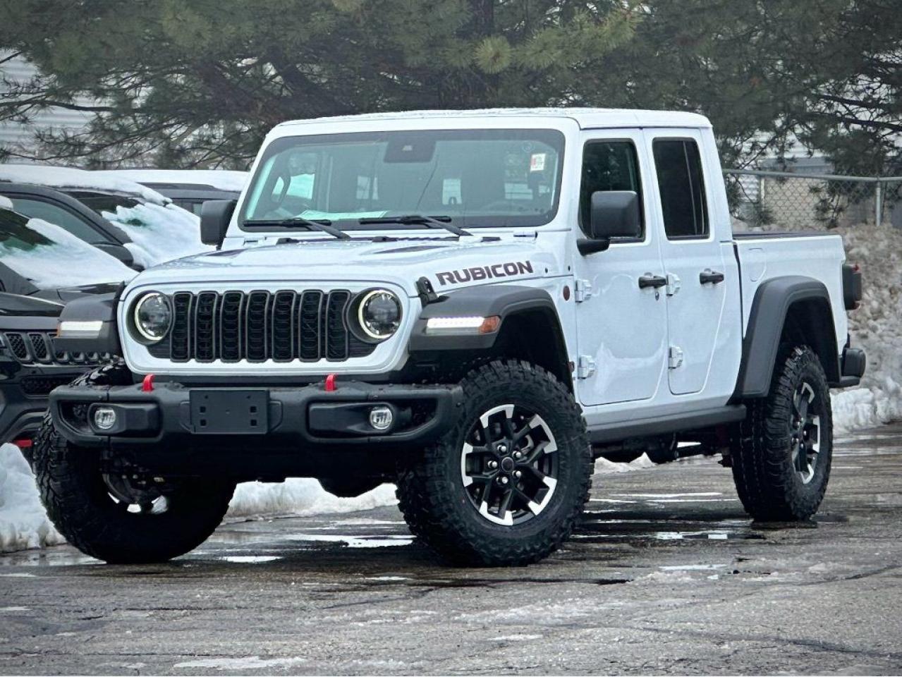 Our New 2024 Jeep Gladiator Rubicon 4X4 is born to break boundaries in Bright White! Powered by a 3.6 Litre Pentastar V6 that supplies 285hp to an 8 Speed Automatic transmission for command of the road and trail. This Four Wheel Drive truck also features heavy-duty Dana axles with locking differentials to keep moving even when things get messy, and it scores nearly approximately 10.7L/100km on the highway. Exclusive Rubicon graphics, skid plates, steel rock rails, fog lamps, steel bumpers, heated power mirrors, alloy wheels, a padded sport bar, and a removable 3-piece hard top give our Gladiator an unmistakable look that enthusiasts love!  Its easy to enjoy your next challenge in our Rubicon cabin, which treats you to supportive cloth seats, a premium-wrapped steering wheel, automatic temperature control, cruise control, keyless entry/ignition, and a Uconnect infotainment system. That makes staying connected a breeze with an 8.4-inch touchscreen, full-color navigation, voice command, Android Auto/Apple CarPlay, Bluetooth, and an Alpine audio system.  Jeeps robust engineering complements advanced features for your safety, including a rearview camera, ABS, traction/stability control, hill-start assist, advanced multistage front airbags, tire pressure monitoring, trailer sway control, and more. Our Gladiator Rubicon is a top-notch towing machine, too! Save this Page and Call for Availability. We Know You Will Enjoy Your Test Drive Towards Ownership!