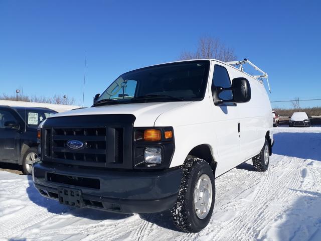 2012 Ford Econoline Cargo van with roof rack and interior shelving