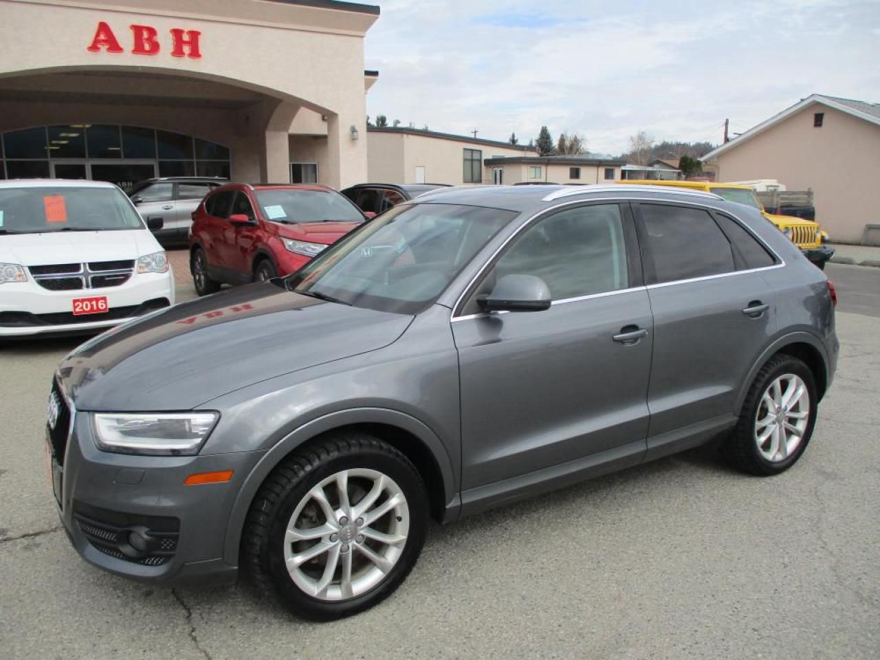 The 2015 Audi Q3 Technik Quattro embodies a fusion of elegance and performance. Powered by a responsive 2.0-liter engine mated to a smooth 6-speed automatic transmission, this SUV delivers a dynamic driving experience with Audis renowned Quattro all-wheel-drive system. Its luxurious interior boasts dual-zone climate control for personalized comfort, complemented by sumptuous leather heated seats offering both style and warmth. Equipped with advanced technology, it features a rear backup camera for enhanced safety and convenience. The panoramic roof amplifies the sense of space and connection with the surroundings. Original BC vehicle, this vehicle carries a prestigious pedigree, promising reliability and performance on every journey. Dlr#9243