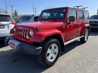 FLAME RED 4-DOOR SAHARA UNLIMITED 4x4 W/ ONLY 83,800 KMS!!! Freedom Top hard top, remote start, running boards, roof rack, 18-inch alloys, 9-speaker premium Alpine audio, Bluetooth, automatic headlights, air conditioning, keyless entry, tow hitch receiver, full power group, full-size spare tire, leather-wrapped steering wheel, lever-style transfer case controls, cruise control and more! This vehicle just landed and is awaiting a full detail and photo shoot. Contact us and book your road test today!