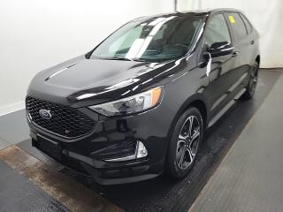 THE PRICE YOU SEE, PLUS GST.  GUARANTEED!2.7 LITER ECOBOOST, TWIN TURBO V-6, 7 SPEED AUTOMATIC, COLD WEATHER PKG, CO-PILOT 360 ASSIST+, PANORAMIC ROOF.    The 2023 Ford Edge ST with the 2.7-liter engine is a high-performance midsize SUV that offers a dynamic driving experience combined with practicality and versatility. The 2.7-liter twin-turbocharged V6 engine produces an impressive 335 horsepower and 380 lb-ft of torque, providing strong acceleration and exhilarating performance. It is paired with a smooth-shifting seven-speed automatic transmission that delivers responsive and precise gear changes. Inside the cabin, the Edge ST offers a comfortable and upscale environment with premium materials and high-quality finishes. The interior is spacious and well-appointed, with plenty of room for passengers and cargo. Features such as leather-trimmed seats, a heated steering wheel, ambient lighting, and a panoramic sunroof enhance the luxury feel of the Edge ST. The 2023 Ford Edge ST also comes equipped with a range of advanced technology and safety features, including a touchscreen infotainment system with Fords SYNC 4 interface, Apple CarPlay and Android Auto compatibility, a premium audio system, adaptive cruise control, lane-keeping assist, blind-spot monitoring, and automatic emergency braking. These features provide connectivity, convenience, and peace of mind for drivers and passengers.Do you want to know more about this vehicle, CALL, CLICK OR COME ON IN!*AMVIC Licensed Dealer; CarProof and Full Mechanical Inspection Included.