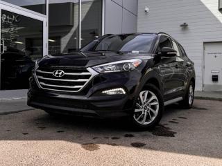 Our inviting 2018 Hyundai Tucson SE is shown off in Ash Black! Its powered by a 2.0 Liter 4 Cylinder engine that produces 164 horsepower while paired to a smooth-shifting 6-Speed automatic transmission.Its absolutely stunning with alloy wheels, roof rails, and a rear roof spoiler.Inside our SE, find a world of comfort and convenience! Settle into leather front heated seats, grip the leather-wrapped heated steering wheel with mounted audio/cruise controls, and look up to see a panoramic sunroof! It also has dual-zone climate control, rear heated seats,AUX/USB inputs for mobile devices, an AM/FM radio thats XM radio ready, an impressive 6 speaker sound system!Our Hyundai gives you peace of mind with a variety of safety features including a backup camera, blind-spot monitoring, a tire pressure monitoring system, stability/traction control, 4-Wheel anti-locking braking system, a multitude of airbags and more! Print this page and call us Now... We Know You Will Enjoy Your Test Drive Towards Ownership! We look forward to showing you why Go Mazda is the best place for all your automotive needs.Go Mazda is an AMVIC licensed business.Please note: this vehicle is showing a CarFax incident in the amount of $10,042.00