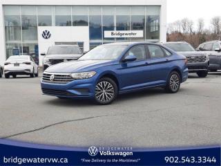 New Price! Silk Blue Metallic 2021 Volkswagen Jetta Highline Apple Carplay | Android Auto | Sirus Xm FWD 8-Speed Automatic with Tiptronic 1.4L TSI Bridgewater Volkswagen, Located in Bridgewater Nova Scotia.Titan Black Seating Surfaces Artificial Leather, 4-Wheel Disc Brakes, 6 Speakers, ABS brakes, Air Conditioning, Alloy wheels, AM/FM radio: SiriusXM, App-Connect (Android Auto/Apple CarPlay/MirrorLink), Auto-dimming Rear-View mirror, Automatic temperature control, Brake assist, Bumpers: body-colour, Delay-off headlights, Driver door bin, Driver vanity mirror, Dual front impact airbags, Dual front side impact airbags, Electronic Stability Control, Exterior Parking Camera Rear, Front anti-roll bar, Front Bucket Seats, Front dual zone A/C, Front reading lights, Front wheel independent suspension, Fully automatic headlights, Heated door mirrors, Heated Front Comfort Bucket Seats, Heated front seats, Illuminated entry, Leather Shift Knob, Leatherette Seating Surfaces, Low tire pressure warning, Navigation System, Occupant sensing airbag, Outside temperature display, Overhead airbag, Overhead console, Panic alarm, Passenger door bin, Passenger vanity mirror, Power door mirrors, Power moonroof: Rail 2 Rail, Power steering, Power windows, Radio data system, Radio: MIBIII 8.0 Touchscreen Infotainment System, Rain sensing wipers, Rear anti-roll bar, Rear reading lights, Rear window defroster, Remote CD player, Remote keyless entry, Security system, Speed control, Speed-sensing steering, Split folding rear seat, Steering wheel mounted audio controls, Tachometer, Telescoping steering wheel, Tilt steering wheel, Traction control, Trip computer, Variably intermittent wipers.Volkswagen Certified Details:* Any remaining new-vehicle limited warranty. Certified Pre-Owned vehicles are eligible for extended warranty coverage, giving you greater peace of mind* Finance rates from 4.99%* A 6-month subscription to Volkswagen 24-hour roadside assistance* Prepaid Maintenance is now available for Certified Pre-Owned Volkswagens. Lock in your maintenance fees by choosing between a 2- or 3-year plan. Vehicles up to 7 years of age are eligible for the purchase of our Prepaid Maintenance plans regardless of mileage. A 3-month SiriusXM all-access trial subscription / Recent college, CEGEP or university Graduates can get a $500 rebate / CARFAX Vehicle History Report. A 3-month SiriusXM all-access trial subscription* A completed 112-point inspection plus mechanical and appearance reconditioning assessment performed by a Volkswagen factory-trained technician