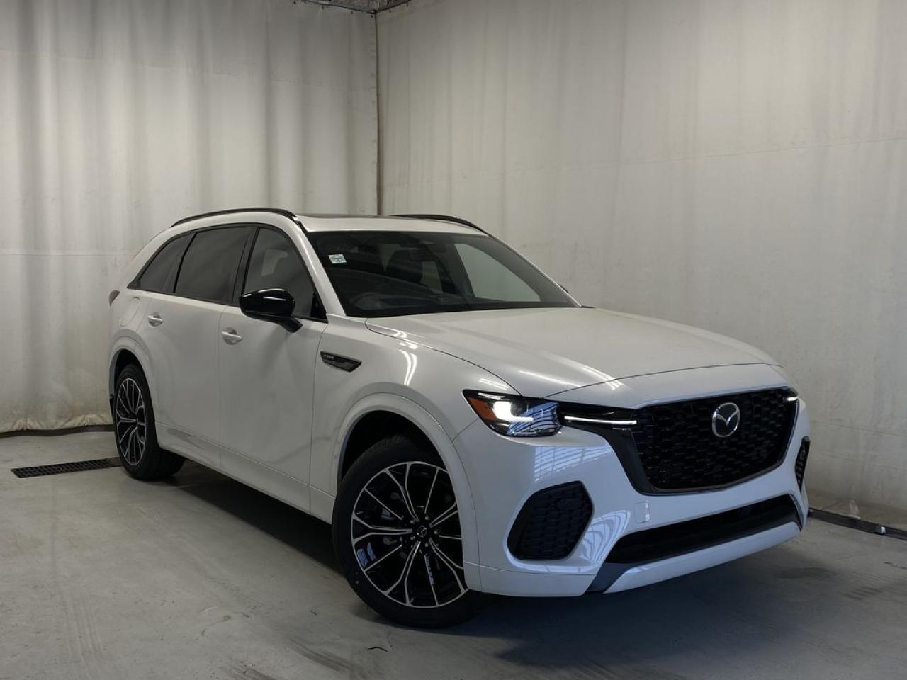 <p>NEW 2025 Mazda CX-70 PHEV GT AWD. Bluetooth, Mi-Drive, 360° View Monitor, Available NAV, Heads-Up-Display, Nappa Leather Upholstery, Rear Parking Sensor, Panoramic Moonroof, Apple CarPlay/Android Auto, Bose Premium Sound System, Wiper De-Icer, Roof Rails, 5-Seater, Heated/Ventilated Front Seats, Heated Steering Wheel, Electronic Parking Brake, Auto Hold, Power Trunk, Rear Climate Control, Front/Rear Parking Sensors, Metallic Alloy Wheels.</p>  <p>Includes:</p>   <p>Standard on 2025 Mazda CX-70 i-ACTIVSENSE + Safety Features (Smart Brake Support-Front, Driver Attention Alert, Rear Cross Traffic Alert, Mazda Radar Cruise Control With Stop & Go, Emergency Lane Keeping with Road Keep Assist, Lane-Keep Assist System, Lane Departure Warning System, Blind Spot Monitoring, Distance & Speed Alert)</p>    <p>Enjoy the journey in our 2025 Mazda CX-70 PHEV GT AWD, which is comfortably capable in Rhodium White Metallic! Motivated by a Hybrid 2.5 Liter Inline 4 and an Electric Motor delivering 42 KM of range, totaling a combined 340hp to an 8 Speed Automatic transmission. This All Wheel Drive SUV also rides with Off-Road, Sport, and Towing Modes, and it sees nearly approximately 9.4L/100km on the highway. A refined design is another benefit of our CX-70. Check out its LED lighting, panoramic moonroof, power liftgate, and alloy wheels.</p>  <p>Our CX-70 cabin treats your family to better travel with heated/ventilated nappa leather power front seats, a leather-wrapped steering wheel, and keyless access/ignition. Digitally dominate daily errands and extraordinary adventures with a 10.25-inch color display, Android Auto/Apple CarPlay, a Commander controller, available NAV, wireless charging, and voice control.</p>  <p>Safety is paramount for Mazda, so youre protected by automatic braking, a rearview camera, adaptive cruise control, blind-spot monitoring, rear cross-traffic alert, lane-keeping assistance, and other smart technologies. Carefully crafted, our CX-70 PHEV GT AWD can be yours today! Save this Page and Call for Availability. We Know You Will Enjoy Your Test Drive Towards Ownership!</p>  <p>Call 587-409-5859 for more info or to schedule an appointment! Listed Pricing is valid for 72 hours. Financing is available, please see dealer for term availability and interest rates. AMVIC Licensed Business.</p>