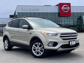 <b>Bluetooth,  Heated Seats,  Rear View Camera,  SiriusXM,  Aluminum Wheels!</b><br> <br>    In the popular, competitive field of compact crossovers, the Ford Escape stands out for its sharp looks, well-appointed interior, and engaging driving dynamics. This  2018 Ford Escape is fresh on our lot in Midland. <br> <br>Although there are many compact SUVs to choose from, few have the styling, performance, and features offered by this 5-passenger Ford Escape. Beyond its strong, efficient drivetrain and handsome styling, this Escape offers nimble handling and a comfortable ride. The interior boasts smart design and impressive features. If you need the versatility of an SUV but want something fuel-efficient and easy to drive, this Ford Escape is just right. This  SUV has 97,261 kms. Its  white gold metallic in colour  . It has a 6 speed automatic transmission and is powered by a  179HP 1.5L 4 Cylinder Engine.  It may have some remaining factory warranty, please check with dealer for details. <br> <br> Our Escapes trim level is SE. This Escape SE offers a satisfying blend of features and value. It comes with a SYNC infotainment system with Bluetooth connectivity, SiriusXM, a USB port, a rearview camera, heated front seats, steering wheel-mounted audio and cruise control, dual-zone automatic climate control, power windows, power doors, aluminum wheels, fog lamps, and more. This vehicle has been upgraded with the following features: Bluetooth,  Heated Seats,  Rear View Camera,  Siriusxm,  Aluminum Wheels,  Steering Wheel Audio Control. <br> To view the original window sticker for this vehicle view this <a href=http://www.windowsticker.forddirect.com/windowsticker.pdf?vin=1FMCU9GDXJUA76720 target=_blank>http://www.windowsticker.forddirect.com/windowsticker.pdf?vin=1FMCU9GDXJUA76720</a>. <br/><br> <br>To apply right now for financing use this link : <a href=https://www.bourgeoisnissan.com/finance/ target=_blank>https://www.bourgeoisnissan.com/finance/</a><br><br> <br/><br>Since Bourgeois Midland Nissan opened its doors, we have been consistently striving to provide the BEST quality new and used vehicles to the Midland area. We have a passion for serving our community, and providing the best automotive services around.Customer service is our number one priority, and this commitment to quality extends to every department. That means that your experience with Bourgeois Midland Nissan will exceed your expectations whether youre meeting with our sales team to buy a new car or truck, or youre bringing your vehicle in for a repair or checkup.Building lasting relationships is what were all about. We want every customer to feel confident with his or her purchase, and to have a stress-free experience. Our friendly team will happily give you a test drive of any of our vehicles, or answer any questions you have with NO sales pressure.We look forward to welcoming you to our dealership located at 760 Prospect Blvd in Midland, and helping you meet all of your auto needs!<br> Come by and check out our fleet of 20+ used cars and trucks and 90+ new cars and trucks for sale in Midland.  o~o