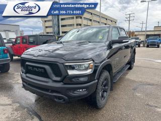 <b>Off-Road Suspension,  Aluminum Wheels,  Sport Performance Hood,  Black Accents,  Proximity Key!</b><br> <br>  Compare at $46986 - Our Price is just $45985! <br> <br>   Beauty meets brawn with this rugged Ram 1500. This  2021 Ram 1500 is fresh on our lot in Swift Current. <br> <br>The Ram 1500 delivers power and performance everywhere you need it, with a tech-forward cabin that is all about comfort and convenience. Loaded with best-in-class features, its easy to see why the Ram 1500 is so popular. With the most towing and hauling capability in a Ram 1500, as well as improved efficiency and exceptional capability, this truck has the grit to take on any task. This  Crew Cab 4X4 pickup  has 98,285 kms. Its  diamond black crystal pearl in colour  . It has an automatic transmission and is powered by a  395HP 5.7L 8 Cylinder Engine.  This unit has some remaining factory warranty for added peace of mind. <br> <br> Our 1500s trim level is Rebel. This menacing Ram 1500 Rebel comes very well equipped with unique aluminum wheels, a sport performance hood, Bilstein off-road suspension with skid plates, Uconnect with a color touchscreen, wireless streaming audio, USB input jacks, and a handy rear view camera. This sweet pickup truck also comes with a power driver seat, a dampened tailgate, electronic shift-on-the-fly transfer case, hill decent control, power heated side mirrors, proximity keyless entry, cruise control, towing equipment, black bumpers with rear step, LED headlights and fog lights and much more. This vehicle has been upgraded with the following features: Off-road Suspension,  Aluminum Wheels,  Sport Performance Hood,  Black Accents,  Proximity Key,  Touchscreen,  Streaming Audio. <br> To view the original window sticker for this vehicle view this <a href=http://www.chrysler.com/hostd/windowsticker/getWindowStickerPdf.do?vin=1C6SRFLT9MN693545 target=_blank>http://www.chrysler.com/hostd/windowsticker/getWindowStickerPdf.do?vin=1C6SRFLT9MN693545</a>. <br/><br> <br>To apply right now for financing use this link : <a href=https://standarddodge.ca/financing target=_blank>https://standarddodge.ca/financing</a><br><br> <br/><br>* Stop By Today *Test drive this must-see, must-drive, must-own beauty today at Standard Chrysler Dodge Jeep Ram, 208 Cheadle St W., Swift Current, SK S9H0B5! <br><br> Come by and check out our fleet of 30+ used cars and trucks and 100+ new cars and trucks for sale in Swift Current.  o~o
