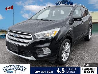 Shadow Black 2017 Ford Escape Titanium 300A 300A 4D Sport Utility EcoBoost 2.0L I4 GTDi DOHC Turbocharged VCT 6-Speed Automatic 4WD 4WD, 3.07 Axle Ratio, Air Conditioning, Alloy wheels, AM/FM radio, Block heater, Canadian Touring Package, Cruise Control, Delay-off headlights, Driver door bin, Driver vanity mirror, Equipment Group 300A, Front dual zone A/C, Front fog lights, Fully automatic headlights, Heated front seats, Passenger door bin, Power driver seat, Power Panoramic Vista Roof, Power steering, Power windows, Rear window defroster, Rear window wiper, Remote keyless entry, Roof rack: rails only, Steering wheel mounted audio controls, Variably intermittent wipers, Voice-Activated Navigation System w/Sony Audio Sys.