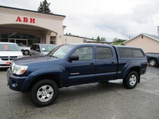 One-owner 2006 Toyota Tacoma SR5 Double Cab 4x4 with a 4.0L V6 engine and a 5-speed automatic transmission. This well-maintained truck features air conditioning, a telescopic steering column, cruise control, keyless entry, a hitch, and a box liner. Comes with a matching canopy. Reliable, rugged, and ready for any adventure. Perfect for work or play