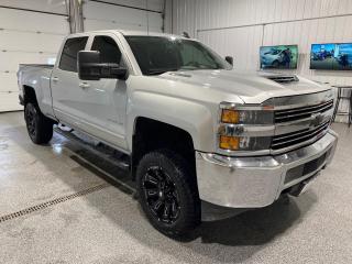 <div>Presenting the robust and stylish 2018 Chevrolet Silverado 2500HD LT, a truck that seamlessly blends power and sophistication. This pre-owned beast is ready to tackle any challenge with its formidable features and dependable performance. </div><br /><div><br></div><br /><div>Dressed in a sleek Silver exterior, the Silverado 2500HD LT commands attention on the road. The trucks bold and aggressive stance is complemented by its rugged design, making it an ideal choice for those who require both functionality and aesthetic appeal. </div><br /><div><br></div><br /><div>Step inside to find a spacious and comfortable Grey interior that offers a welcoming atmosphere. The interior is designed with practicality in mind, ensuring that both driver and passengers experience maximum comfort and convenience during their journey.</div><br /><div><br></div><br /><div>Under the hood, this Silverado is powered by a 6.6L Turbo V8 diesel engine, capable of delivering immense power and torque. Whether youre hauling heavy loads or navigating through rough terrains, the 4X4 drivetrain provides excellent traction and stability.</div><br /><div><br></div><br /><div>Noteworthy features of the 2018 Chevrolet Silverado 2500HD LT include:</div><br /><div><br></div><br /><div>- Keyless Entry </div><br /><div>- 6.6L Turbo Diesel V8 Engine</div><br /><div>- Automatic Transmission</div><br /><div>- 4X4 Drivetrain for superior traction</div><br /><div>- Durable and spacious 4-door configuration</div><br /><div>- Diesel fuel type for robust performance</div><br /><div><br></div><br /><div>This truck is not just about power; its also about providing a comfortable and safe driving experience. With its combination of advanced features and rugged capabilities, the 2018 Chevrolet Silverado 2500HD LT is the perfect vehicle for those who demand more from their truck. Whether youre using it for work or play, this Silverado is built to exceed expectations. </div><br /><div></div><br /><div><span>For your peace of mind we include a 3 Day/600 km No Hassle Return Policy, 30 day exchange privilege, Minimum Warranties with 24 Hour Roadside Assistance, check for safety recalls, and include a CarFax History Report. Home Delivery is free up to 200 km. Dealer Permit # 5471</span></div>