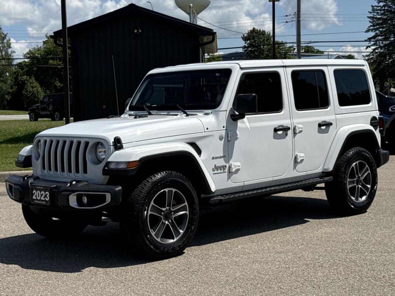 <div>**2023 Jeep Wrangler Unlimited Sahara  A Rugged Classic with Modern Comfort**</div><br /><div><span>Discover the perfect blend of rugged adventure and refined comfort with this stunning 2023 Jeep Wrangler Unlimited Sahara. Finished in a sleek, white exterior with a painted-to-match top, this SUV stands out with its iconic style and premium features.</span><br></div><br /><div><span>Equipped with an automatic transmission for smooth driving, this Wrangler is ready for any terrain. It features DeeZee running boards for easy access, a rear vision camera for enhanced safety, and Uconnect technology to keep you connected on the go.</span><br></div><br /><div><span>At Easton Auto Sales, we are OMVIC certified and a proud UCDA member, ensuring a trustworthy and seamless buying experience. Located in Gananoque, just minutes from Brockville and Kingston, were conveniently situated for your visit.</span><br></div><br /><div><span>Dont miss the chance to own this exceptional Jeep Wrangler Unlimited Sahara. Call us today at 613-561-5172 to schedule your test drive and experience the adventure waiting for you.</span><br></div>