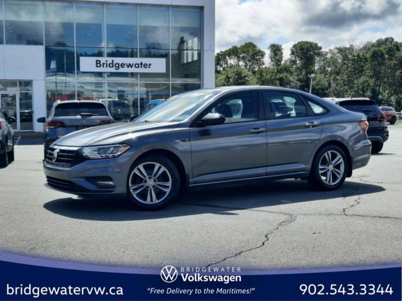 Gray 2019 Volkswagen Jetta Highline R-Line NEW MVI | DEALER MAINTAINED | $119 Bi Weekly | ONE FWD 6-Speed Manual 1.4L TSI Bridgewater Volkswagen, Located in Bridgewater Nova Scotia.Storm Gray/Black w/Perforated V-Tex Leatherette Seat Trim, 4-Wheel Disc Brakes, 6 Speakers, ABS brakes, Air Conditioning, Alloy wheels, AM/FM radio: SiriusXM, App-Connect (Android Auto/Apple CarPlay/MirrorLink), Auto-dimming Rear-View mirror, Automatic temperature control, Brake assist, Bumpers: body-colour, Delay-off headlights, Driver door bin, Driver vanity mirror, Dual front impact airbags, Dual front side impact airbags, Electronic Stability Control, Exterior Parking Camera Rear, Front anti-roll bar, Front Bucket Seats, Front dual zone A/C, Front reading lights, Front wheel independent suspension, Fully automatic headlights, Heated door mirrors, Heated Front Comfort Seats, Heated front seats, Illuminated entry, Leather Shift Knob, Leatherette Seating Surfaces, Low tire pressure warning, Occupant sensing airbag, Outside temperature display, Overhead airbag, Overhead console, Panic alarm, Passenger door bin, Passenger vanity mirror, Power door mirrors, Power moonroof: Rail 2 Rail, Power steering, Power windows, Radio data system, Radio: Composition Media w/8.0 Touchscreen, Rain sensing wipers, Rear anti-roll bar, Rear reading lights, Rear window defroster, Remote CD player, Remote keyless entry, Security system, Speed control, Speed-sensing steering, Split folding rear seat, Steering wheel mounted audio controls, Tachometer, Telescoping steering wheel, Tilt steering wheel, Traction control, Trip computer, Variably intermittent wipers, Wheels: 16 x 6.5J Rama Diamond Alloy (Dual-Tone).Certification Program Details: 2 years MVI Full Tank of Gas Full Detail Free Carfax