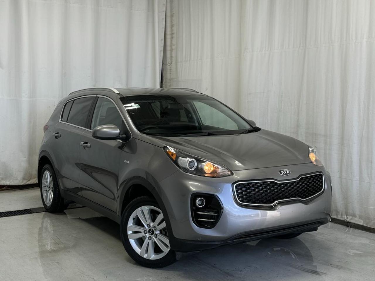 <p>Fully Inspected, ALL Work Complete and Included in Price! Call Us For More Info at 587-409-5859</p>   <p>This 2018 Kia Sportage LX AWD looks impressive in Silver! Powered by a 2.4 Liter 4 Cylinder that offers 181hp paired with a responsive 6 Speed Automatic transmission with Sportmatic. You will enjoy the ride in this All Wheel Drive SUV while seeing nearly approximately 7.8L/100km on the highway, plus appreciate the rock-solid stance. Kia delivers your desired bold style with its bright chrome accents, privacy glass, and distinct projector headlights.</p>  <p>Built for your lifestyle, the LX interior has plenty of room for your tallest friends and all their gear. Imagine yourself settling into the nicely bolstered and supportive seats. Then acquaint yourself with a rear camera display, Bluetooth®, steering wheel controls, drive mode select, a USB/auxiliary jack, power accessories, and other comfort and convenience features just waiting to spoil you.</p>  <p>In challenging driving situations, our Kia ensures your sense of security with ABS, hill start control, downhill brake control, electronic stability control, advanced airbags, and even its innovative Iso-Structure unibody that boasts chassis rigidity based on advanced high-strength steel. Practically perfect, your Sportage LX awaits! Save this Page and Call for Availability. We Know You Will Enjoy Your Test Drive Towards Ownership!</p>  <p>Call 587-409-5859 for more info or to schedule an appointment! Listed Pricing is valid for 72 hours. Financing is available, please see dealer for term availability and interest rates. AMVIC Licensed Business.</p>