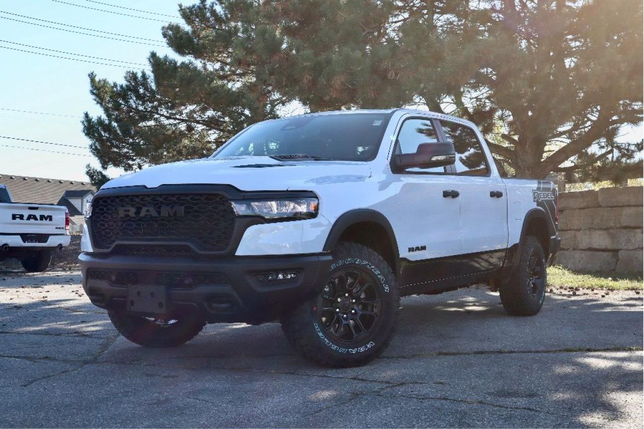 Dealer installed Spray in bedliner additional $799 and running boards $997  Dynamic and defiant, our New 2025 RAM 1500 Rebel Crew Cab 4X4 with the Level 1 Pack in Bright White w/ Diamond Black Crystal Pearl Two-Tone dares you to find your limits! Motivated by a Twin-TurboCharged 3.0 Litre Hurricane 6 Cylinder delivering 420hp to an 8 Speed Automatic transmission engineered for off-road domination. A raised ride height, performance shocks, and a shift-on-demand transfer case can take this Four Wheel Drive truck further down the trail, achieving approximately 9.8L/100km on the highway. Our fierce RAM features LED lighting, fog lamps, a sport performance hood, bold graphics, alloy wheels, off-road fender flares, robust skid plates, and our Level 1 Pack for a power-release tailgate and multifunction mirrors.  Our Rebel cabin is ready for rough terrain thanks to its heated cloth front seats, eight-way power for the driver, a heated-wrapped steering wheel, dual-zone automatic climate control, a power rear window, remote start, and our Level 1 Pack for power-adjustable pedals and wireless charging. Off-Road Info Pages enhance the infotainment system, which bundles a 12-inch driver display, 12-inch touchscreen, full-color navigation, WiFi compatibility, Android Auto®/Apple CarPlay®, Bluetooth®, voice control, and nine-speaker audio.  For safetys sake, RAM supplies front/rear auto braking, blind-spot monitoring, adaptive cruise control, active lane management, trailer sway damping, hill-start assistance, and more. Committed to truck leadership, our 1500 Rebel is a compelling choice! Save this Page and Call for Availability. We Know You Will Enjoy Your Test Drive Towards Ownership!