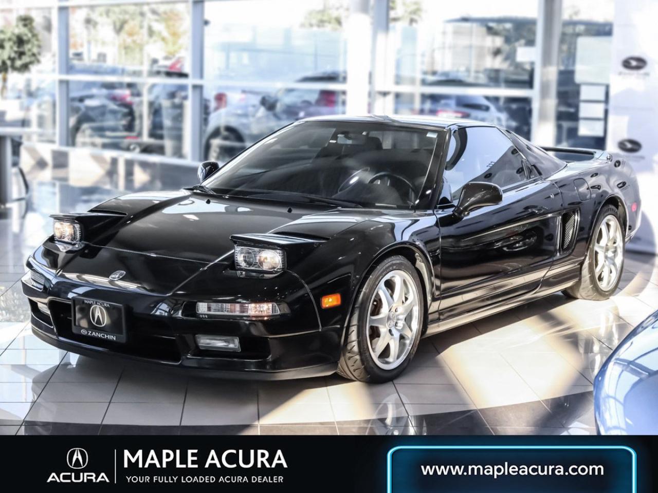 The car is powered by a 3.0-liter VTEC V6 paired with a five-speed manual transaxle and is finished in Berlina Black over Ebony leather upholstery. This NSX is all original parts with only 2 owners under record. Its is featured with aluminum bodywork, and is finished in Berlina Black. Exterior details include pop-up headlights, an integrated rear wing, side air intakes, power-adjustable side mirrors, daytime running lights, and dual exhaust outlets. The cabin features power-adjustable sport seats upholstered in Ebony leather. Interior amenities include automatic climate control, cruise control, a Bose sound system, NSX-branded floor mats, and a cassette stereo linked to a six-disc CD changer. The stainless-steel door sill plates are stamped with the cars serial number. The vehicle has also had all its up-to-date service done here exclusively at Maple Acura and the water pump and timing belt have been completed as well.