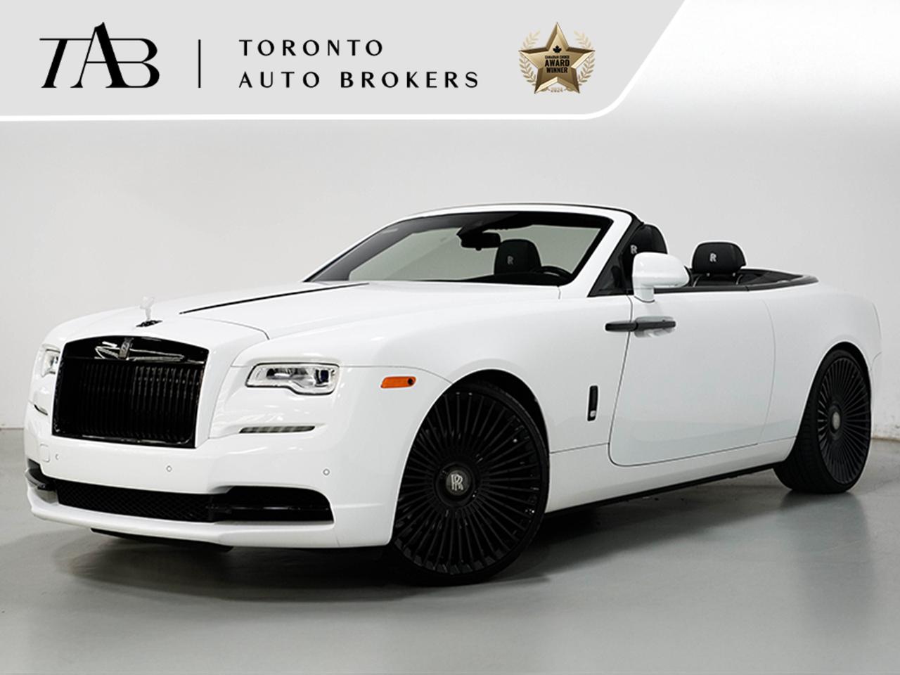 This 2016 Rolls-Royce Dawn Base V12 has Clean Carfax Report. It is the epitome of open-top luxury, blending timeless elegance with cutting-edge engineering. As a cabriolet, it offers an unmatched open-air driving experience, allowing drivers to bask in the beauty of the surroundings while enjoying the ultimate in luxury craftsmanship. Every detail, from the hand-stitched leather interior to the bespoke design touches, exudes exclusivity. The powerful V12 engine ensures that performance is never compromised, delivering smooth and effortless power. Riding on 24-inch forge wheels, this Dawn combines the grace of a classic Rolls-Royce with a modern, head-turning appeal.

Key Features:

6.6L twin-turbocharged V12 engine
563 horsepower 
24-inch forged wheels 
Cabriolet design 
Eight-speed automatic transmission
Premium leather interior with bespoke detailing
Hand-crafted wood veneer trim
Adaptive cruise control with full stop and go
Night vision camera 
Heated and ventilated front seats
Soft-closing doors
Bespoke audio system with immersive sound
Keyless entry and push-button start
Air suspension 
LED adaptive headlights for improved visibility
Heads-up display 
Navigation system with real-time traffic updates

NOW OFFERING 3 MONTH DEFERRED FINANCING PAYMENTS ON APPROVED CREDIT.

WE OFFER THE BEST FINANCE RATES, AND DONT CHARGE ANY FINANCING FEE

Looking for a top-rated pre-owned luxury car dealership in the GTA? Look no further than Toronto Auto Brokers (TAB)! Were proud to have won multiple awards, including the 2024 AutoTrader Best Priced Dealer, 2024 CBRB Dealer Award, the Canadian Choice Award 2024, the 2024 BNS Award, the 2024 Three Best Rated Dealer Award, and many more!

With 30 years of experience serving the Greater Toronto Area, TAB is a respected and trusted name in the pre-owned luxury car industry. Our 30,000 sq.Ft indoor showroom is home to a wide range of luxury vehicles from top brands like BMW, Mercedes-Benz, Audi, Porsche, Land Rover, Jaguar, Aston Martin, Bentley, Maserati, and more. 

At TAB, were committed to providing a no-pressure environment and honest work ethics. As a family-owned and operated business, we treat every customer like family and ensure that every interaction is a positive one. Come experience the TAB Lifestyle at its truest form, luxury car buying has never been more enjoyable and exciting!

We offer a variety of services to make your purchase experience as easy and stress-free as possible. From competitive and simple financing and leasing options to extended warranties, aftermarket services, and full history reports on every vehicle, we have everything you need to make an informed decision. We welcome every trade, even if youre just looking to sell your car without buying, and when it comes to financing or leasing, we offer same day approvals, with access to over 50 lenders, including all of the banks in Canada. Feel free to check out your own Equifax credit score without affecting your credit score, simply click on the Equifax tab above and see if you qualify.

So if youre looking for a luxury pre-owned car dealership in Toronto, look no further than TAB! We proudly serve the GTA, including Toronto, Etobicoke, Woodbridge, North York, York Region, Vaughan, Thornhill, Richmond Hill, Mississauga, Scarborough, Markham, Oshawa, Peteborough, Hamilton, Newmarket.

Call us today or visit our website to learn more about our inventory and services. And remember, all prices exclude applicable taxes and licensing, and vehicles can be certified at an additional cost of $999.