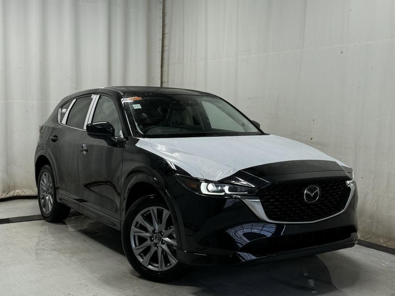 <p>NEW 2025 CX-5 GT AWD. Bluetooth, Skyactiv-G 2.5 L (Inline-4) Cylinder Deactivation. Backup Cam, Available NAV, Leather Heated/Ventilated Seats, Power Front Seats, Memory Driver Seat, Rear Heated Seats, Wireless Apple CarPlay/Android Auto, Wireless Phone Charger, Bose Premium Sound System, Advanced Keyless Remote Entry, Tilt/Sliding Moonroof, Power Trunk, Adaptive Cruise Control, Heated Steering Wheel, Wiper Blade De-Icer, Auto Dual-Zone Climate Control, Rear Air Vents, Auto Rain-Sensing Wipers, Electronic Parking Brake, Heated Mirrors, 19 Silver Metallic Alloy Wheels</p>  <p>Includes:</p> <p>i-ACTIVSENSE + Safety Features (Smart City Brake Support-Front, Cruise Traffic Support, Rear Cross Traffic Alert, Mazda Radar Cruise Control With Stop & Go, Distance Recognition Support System, Lane-Keep Assist System, Lane Departure Warning System, Advanced Blind Spot Monitoring)</p>  <p>A joy to drive, our 2025 Mazda CX-5 GT AWD radiates refined style in Jet Black Mica! Motivated by a 2.5 Liter 4 Cylinder that delivers 187hp tethered to a paddle-shifted 6 Speed Automatic transmission. You can put that strength to good use with the added traction of torque vectoring, and this All Wheel Drive SUV returns nearly approximately 7.8L/100km on the highway. Our CX-5 also has an expressive design with bold details like 19-inch alloy wheels, a rear roof spoiler, and bright-tipped dual exhaust outlets.</p>  <p>Our GT cabin is no ordinary interior. Its tailor-made for better travel with heated leather power front seats, a leather-wrapped steering wheel, automatic climate control, pushbutton ignition, and keyless access. Mazda makes connecting easy by providing a 10.25-inch central display, a multifunction Commander controller, Apple CarPlay/Android Auto, Bluetooth, voice control, and six-speaker audio. The versatile rear cargo space adds adventure-friendly functionality.</p>  <p>Safety is a high priority for Mazda, which helps protect you and your loved ones with automatic emergency braking, adaptive cruise control, a rearview camera, lane-keeping assistance, blind-spot monitoring, and other intelligent technologies. With all that, our CX-5 GT is here to transcend the ordinary! Save this page, Come in for a Qualified Test Drive. We Know You Will Enjoy Your Test Drive Towards Ownership!</p>  <p>Call 587-409-5859 for more info or to schedule an appointment! Listed Pricing is valid for 72 hours. Financing is available, please see dealer for term availability and interest rates. AMVIC Licensed Business.</p>