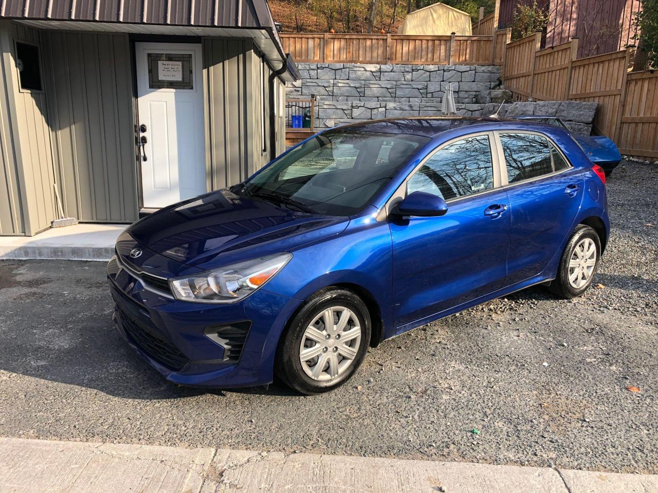 <p>Looking for a reliable and stylish daily driver? Look no further than this 2021 Kia Rio LX PLUS, available at Top Gun Auto Sales. This sleek blue hatchback is equipped with a powerful 1.6L I4 engine and a smooth automatic transmission, making it a joy to drive around town. The spacious interior features black cloth upholstery, perfect for a comfortable ride. With only 82,750 km on the odometer, this Kia Rio is practically brand new!</p><p>This Rio LX PLUS boasts an impressive array of features designed to enhance your driving experience and keep you safe. The vehicle is packed with modern conveniences like Apple CarPlay and Bluetooth connectivity for seamless integration of your smartphone. Enjoy the convenience of keyless entry and remote start, and stay safe with advanced safety features like anti-lock brakes, traction control, and a rearview camera.</p><p>Here are five of the most sizzling features of this 2021 Kia Rio LX PLUS:</p><ul><li><strong>Apple CarPlay and Bluetooth Connectivity:</strong> Stay connected and entertained on the road.</li><li><strong>Keyless Entry and Remote Start:</strong> Enjoy the convenience of effortless entry and remote start.</li><li><strong>Rearview Camera:</strong> Maneuver with confidence, thanks to the added visibility.</li><li><strong>Heated Mirrors:</strong> Clear your view on chilly mornings with heated side mirrors.</li><li><strong>Premium Sound System:</strong> Enjoy your favorite tunes with crisp, clear audio quality.</li></ul><p>Stop by Top Gun Auto Sales today to experience this exceptional Kia Rio for yourself.</p><p><em>Powered by AutoIntelligence™ AI</em></p><p><em>THE SELLING PRICE IS PLUS TAX AND YOUR LICENCE FEE. PRICE INCLUDES CERTIFICATION!</em></p><p><em>2 KEYS, REVERSE CAMERA, HEATED SEATS, CARPLAY!</em></p>