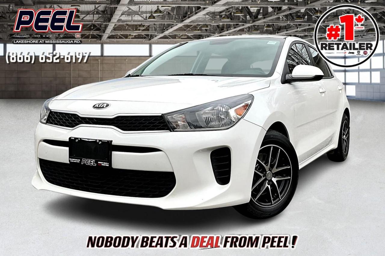 COME SEE WHY NOBODY BEATS A DEAL FROM PEEL! Your Source for ALL make and models used cars and trucks. Canadas #1 Stellantis Retailer for 8 years & counting!!

2020 Kia Rio LX FWD | 1.6L 4Cyl | Snow White Pearl | 6 Speed Manual Transmission | Heated Cloth Bucket Seats | Heated Steering Wheel | Upgraded 15" Alloy Wheels | Bluetooth

One Owner Clean Carfax

Enjoy the simplicity and efficiency of driving with this 2020 Kia Rio LX FWD in elegant Snow White Pearl. Powered by a fuel-saving 1.6L 4-cylinder engine and paired with a 6-speed manual transmission, this Rio is perfect for drivers who appreciate engaging performance and outstanding fuel economy. Inside, youll find heated cloth bucket seats and a heated steering wheela cozy bonus for colder days. Stay connected with Bluetooth for hands-free convenience, while the upgraded 15" alloy wheels add a stylish touch to this compact ride. With one owner and a clean Carfax, this Kia Rio is a dependable and economical choice for daily commutes and city driving alike.
______________________________________________________

Engage & Explore with Peel Chrysler: Whether youre inquiring about our latest offers or seeking guidance, 1-866-652-6197 connects you directly. Dive deeper online or connect with our team to navigate your automotive journey seamlessly.

WE TAKE ALL TRADES & CREDIT. WE SHIP ANYWHERE IN CANADA! OUR TEAM IS READY TO SERVE YOU 7 DAYS!
______________________________________________________

*FREE CarFax (click the link above to check it out at no cost to you!)*

*FULLY CERTIFIED! (Have you seen some of these other dealers stating in their advertisements that certification is an additional fee? NOT HERE! Our certification is already included in our low sale prices to save you more!)

______________________________________________________

Peel Chrysler  A Trusted Destination: Based in Port Credit, Ontario, we proudly serve customers from all corners of Ontario and Canada including Toronto, Oakville, North York, Richmond Hill, Ajax, Hamilton, Niagara Falls, Brampton, Thornhill, Scarborough, Vaughan, London, Windsor, Cambridge, Kitchener, Waterloo, Brantford, Sarnia, Pickering, Huntsville, Milton, Woodbridge, Maple, Aurora, Newmarket, Orangeville, Georgetown, Stouffville, Markham, North Bay, Sudbury, Barrie, Sault Ste. Marie, Parry Sound, Bracebridge, Gravenhurst, Oshawa, Ajax, Kingston, Innisfil and surrounding areas. On our website www.peelchrysler.com, you will find a vast selection of new vehicles including the new and used Ram 1500, 2500 and 3500. Chrysler Grand Caravan, Chrysler Pacifica, Jeep Cherokee, Wrangler and more. All vehicles are priced to sell. We deliver throughout Canada. website or call us 1-866-652-6197. 

Your Journey, Our Commitment: Beyond the transaction, Peel Chrysler prioritizes your satisfaction. While many of our pre-owned vehicles come equipped with two keys, variations might occur based on trade-ins. Regardless, our commitment to quality and service remains steadfast. Experience unmatched convenience with our nationwide delivery options. All advertised prices are for cash sale only. Optional Finance and Lease terms are available. A Loan Processing Fee of $499 may apply to facilitate selected Finance or Lease options. If opting to trade an encumbered vehicle towards a purchase and require Peel Chrysler to facilitate a lien payout on your behalf, a Lien Payout Fee of $299 may apply. Contact us for details. Peel Chrysler Pre-Owned Vehicles come standard with only one key.