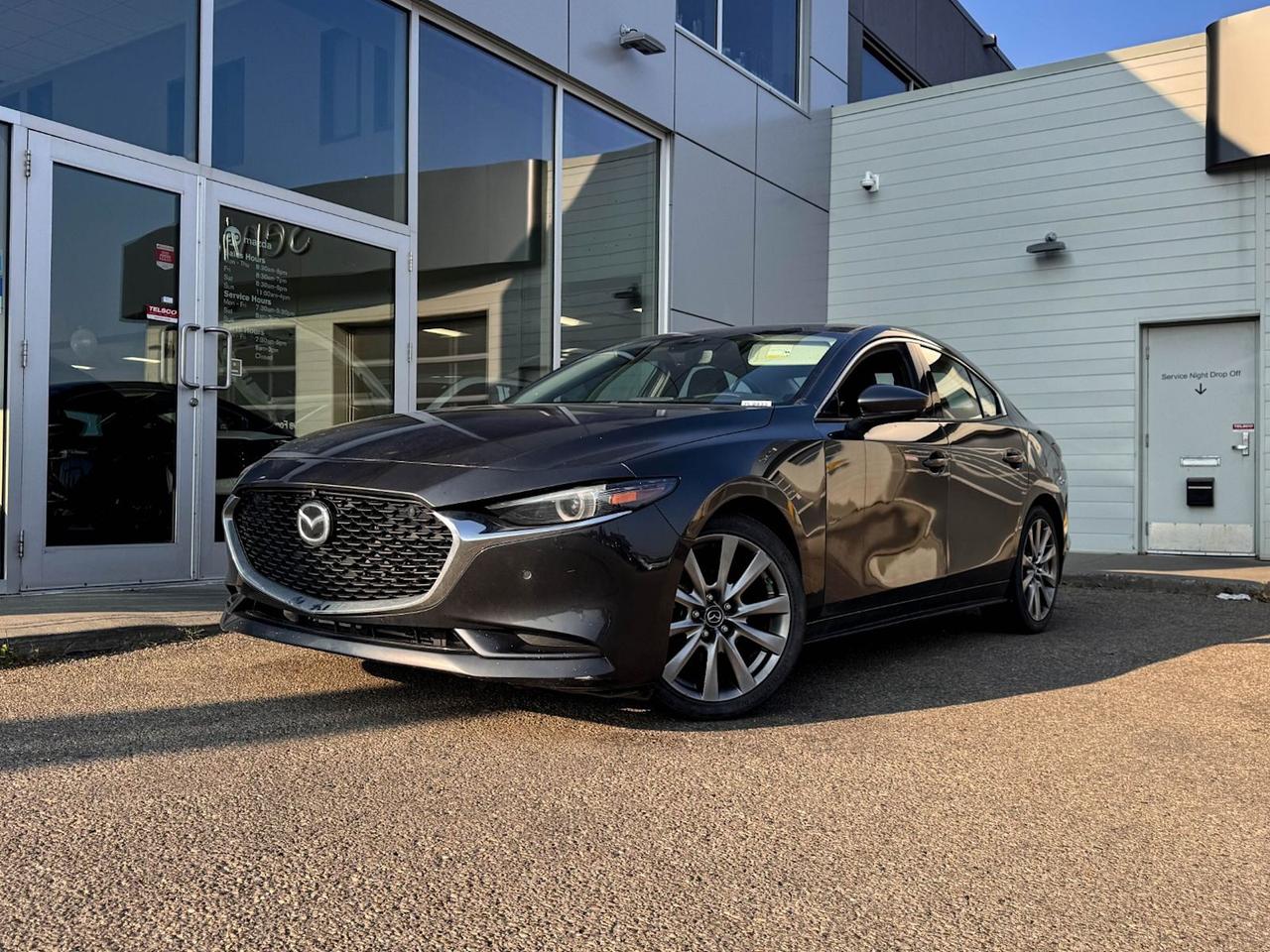 Look smart behind the wheel of this 2021 Mazda3 GT Sedan in Machine Grey Metallic! Its powered by a proven 2.5 Liter 4 Cylinder that offers 184 horsepower while paired to a 6-Speed Automatic transmission with Manual-shift mode for incredible passing performance. Aerodynamic lines and sweet curves are enhanced by the impressive exterior features that include a bold black grille, gorgeous wheels, rear spoiler, dual sport exhaust, LED headlights taillights, and fog lights. Open the door to our GT to find a world of comfort and convenience with a power sunroof, leather seats, driver memory settings, heated front seats, a leather-wrapped heated steering wheel with mounted audio/cruise controls, dual-zone climate control, and Bluetooth hands-free phone capability.Space is abundant for both cargo and passengers with 60/40 split fold-down rear seats and plenty of room for 5.Our Mazda gives you peace of mind with a variety of safety features including a back-up camera, a lane departure system, dusk-sensing headlights, stability/traction control, and more! Print this page and call us Now... We Know You Will Enjoy Your Test Drive Towards Ownership! We look forward to showing you why Go Mazda is the best place for all your automotive needs. Go Mazda is an AMVIC licensed business.Please note this vehicle has been registered in the province of Ontario, Saskatchewan and Manitoba, and was previously used as Fleet