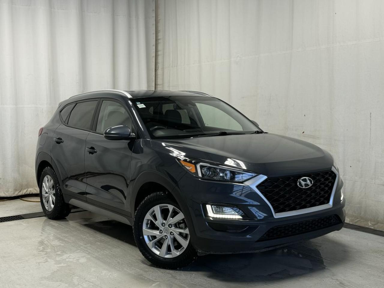 By the beard of Zeus, feast your eyes upon this majestic chariot, the 2020 Hyundai Tucson Preferred! Low Kilometers. Backup Camera, Cruise Control, Heated Steering Wheel, Bluetooth, Heated F/R Seats, Cloth Upholstery, Keyless Entry, Forward Collision Alert, Roof Rails, A/C, Power Windows/Locks/Mirrors, Tilt/Telescopic Steering Wheel, Lane Departure Warning, Traction Control, Keyless Remote, Lane Keep Assist, Rear Cross Traffic Alert, Hill Descent Control, Halogen Headlights, Rear Window Defrost, Fog Lights, Alloy Wheels, AM/FM Radio, Steering Wheel Audio Controls, USB/AUX Input, Apple CarPlay & Android Auto! Like a phoenix rising from the ashes, this alluring BLUE steed with its plush Black interior has soared through 83,502 kilometers, and is just hitting its stride.



Dressed to impress, this Tucson doesnt just turn heads  it spins them right around with features like a HEATED STEERING WHEEL for those frosty Alberta mornings and LANE DEPARTURE WARNING to keep you as straight as a flute. Its as sure-footed as a mountain goat, thanks to the All Wheel Drive system, and with a 6-Speed Automatic Transmission, it glides smoother than a jazz saxophone solo.



And lets not forget the creature comforts  were talking about a cabin so welcoming, youll feel like youre in a warm embrace with HEATED SEATS for both you and your lucky passengers. Plus, BLIND SPOT SENSOR and REAR CROSS TRAFFIC ALERT to watch your back better than your best buddy.



This Hyundai Tucson is more than just a mode of transport; its a rolling testament to your impeccable taste. So why settle for the mundane when you can drive a legend? Come and witness the allure of this pre-loved gem. Its not just a car; its a statement. Stock Number: 200158 





 Call 587-409-5859 for more info or to schedule an appointment! Fully Inspected, ALL Work Complete and Included in Price! Listed Pricing is valid for 72 hours. Financing is available, please see dealer for term availability and interest rates. AMVIC Licensed Business.