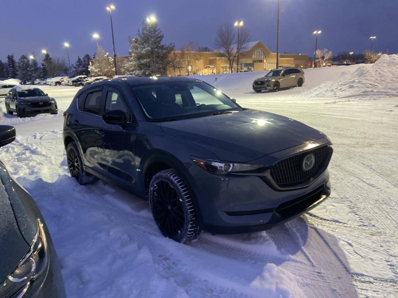 <p>Fully Inspected, ALL Work Complete and Included in Price! Call Us For More Info at 587-409-5859</p>  <p>Sleek, stylish, and ready to turn heads, the 2021 Mazda CX-5 Kuro Edition AWD is the SUV for those who crave sophistication with a side of adventure. Wrapped in exclusive Polymetal Grey, this special edition stands out with bold 19-inch black alloy wheels and a blacked-out grille that whispers, I mean business.</p>  <p>Step inside, and youre greeted by Garnet Red leather seats with elegant stitchinga cabin that feels like a first-class lounge. The driver-centric cockpit ensures every control is within reach, while the heated front seats and steering wheel keep you cozy during chilly drives.</p>  <p>Under the hood, the 2.5L Skyactiv engine delivers 187 horsepower, paired with Mazdas i-Activ AWD for confident handling in all weather conditions. Whether youre weaving through city streets or exploring winding country roads, the CX-5s G-Vectoring Control Plus makes every drive smooth and exhilarating.</p>  <p>Stay connected with the 10.25-inch infotainment display, Apple CarPlay, and Android Auto. Safetys also on point, thanks to features like Blind Spot Monitoring and Smart City Brake Support.</p>  <p>The 2021 CX-5 Kuro Edition blends sporty performance, luxury, and exclusivity in a way only Mazda can. Ready to elevate your daily drive?</p>  <p>Call 587-409-5859 for more info or to schedule an appointment! Listed Pricing is valid for 72 hours. Financing is available, please see dealer for term availability and interest rates. AMVIC Licensed Business.</p>