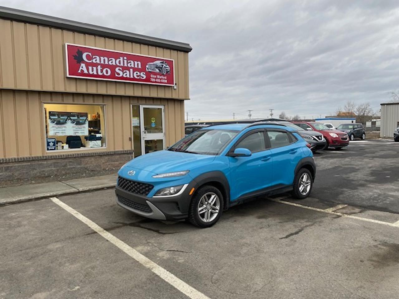 <p>Looking for a stylish and reliable compact SUV that can handle anything the Canadian winter throws your way? Look no further than this 2022 Hyundai KONA 2.0L Essential AWD, available now at Canadian Auto Sales NL. This sleek blue beauty features a spacious and comfortable grey interior, perfect for everyday commutes and weekend adventures. With its powerful 4-cylinder engine and smooth CVT transmission, this KONA delivers a responsive and enjoyable driving experience.</p><p>This pre-owned KONA has only 54,638km on the odometer, ensuring youre getting a vehicle thats barely broken in. Its packed with features to keep you safe and comfortable on the road, including anti-lock brakes, automatic headlights, heated mirrors, and a comprehensive security system.</p><p>Here are five of the most sizzling features that make this KONA stand out:</p><ol><li><strong>All-Wheel Drive:</strong> Conquer any road conditions with confidence, thanks to the KONAs reliable AWD system.</li><li><strong>Spacious Interior:</strong> Enjoy ample legroom and cargo space, making this SUV perfect for families and adventurers alike.</li><li><strong>Fuel Efficiency:</strong> The KONAs efficient 4-cylinder engine helps you save money at the pump, making it a smart choice for everyday driving.</li><li><strong>Modern Technology:</strong> Stay connected and entertained with the KONAs advanced infotainment system, featuring a touchscreen display and smartphone integration.</li><li><strong>Sleek Design:</strong> Turn heads wherever you go with the KONAs stylish and modern exterior.</li></ol><p>Visit Canadian Auto Sales NL today to take this stunning KONA for a test drive and experience its exceptional blend of style, performance, and value.</p><p><em>Powered by AutoIntelligence™ AI</em></p>