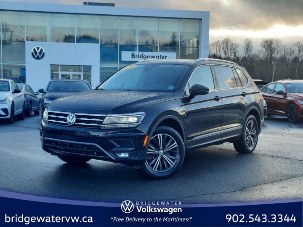 New Price! Deep Black Pearl 2021 Volkswagen Tiguan Highline 4Motion | Apple CarPlay | Android Auto | Sirus XM AWD 8-Speed Automatic with Tiptronic 2.0L TSI Bridgewater Volkswagen, Located in Bridgewater Nova Scotia.AWD, 3.33 Axle Ratio, 4-Wheel Disc Brakes, 9 Speakers, ABS brakes, Air Conditioning, Alloy wheels, AM/FM radio: SiriusXM, Auto High-beam Headlights, Auto-dimming Rear-View mirror, Automatic temperature control, Brake assist, Bumpers: body-colour, Compass, Delay-off headlights, Driver door bin, Driver vanity mirror, Dual front impact airbags, Dual front side impact airbags, Electronic Stability Control, Four wheel independent suspension, Front anti-roll bar, Front Bucket Seats, Front dual zone A/C, Front fog lights, Front reading lights, Fully automatic headlights, Heated door mirrors, Heated front seats, Heated Front Sport Seats, Heated steering wheel, Illuminated entry, Leather Seating Surfaces, Leather Shift Knob, Low tire pressure warning, Memory seat, Navigation System, Occupant sensing airbag, Outside temperature display, Overhead airbag, Overhead console, Panic alarm, Passenger door bin, Passenger vanity mirror, Power door mirrors, Power driver seat, Power Liftgate, Power moonroof, Power steering, Power windows, Radio data system, Radio: Fender Premium Audio System, Rain sensing wipers, Rear anti-roll bar, Rear reading lights, Rear window defroster, Rear window wiper, Remote keyless entry, Roof rack: rails only, Security system, Speed control, Speed-sensing steering, Split folding rear seat, Spoiler, Standard Suspension, Steering wheel mounted audio controls, Tachometer, Telescoping steering wheel, Tilt steering wheel, Traction control, Trip computer, Turn signal indicator mirrors, Variably intermittent wipers, Wheels: 7J x 18 Nizza Alloy.Volkswagen Certified Details:* A completed 112-point inspection plus mechanical and appearance reconditioning assessment performed by a Volkswagen factory-trained technician* Prepaid Maintenance is now available for Certified Pre-Owned Volkswagens. Lock in your maintenance fees by choosing between a 2- or 3-year plan. Vehicles up to 7 years of age are eligible for the purchase of our Prepaid Maintenance plans regardless of mileage. A 3-month SiriusXM all-access trial subscription / Recent college, CEGEP or university Graduates can get a $500 rebate / CARFAX Vehicle History Report. A 3-month SiriusXM all-access trial subscription* Finance rates from 4.99%* Any remaining new-vehicle limited warranty. Certified Pre-Owned vehicles are eligible for extended warranty coverage, giving you greater peace of mind* A 6-month subscription to Volkswagen 24-hour roadside assistanceReviews:* Owners and experts alike almost universally count the Tiguans ride quality, highway manners, interior, and overall easy-to-drive character among its most valuable assets. The central touchscreen infotainment system and all-digital instrument cluster are commonly listed as feature favourites, as they add a high-tech flair to the driving environment. Source: autoTRADER.ca