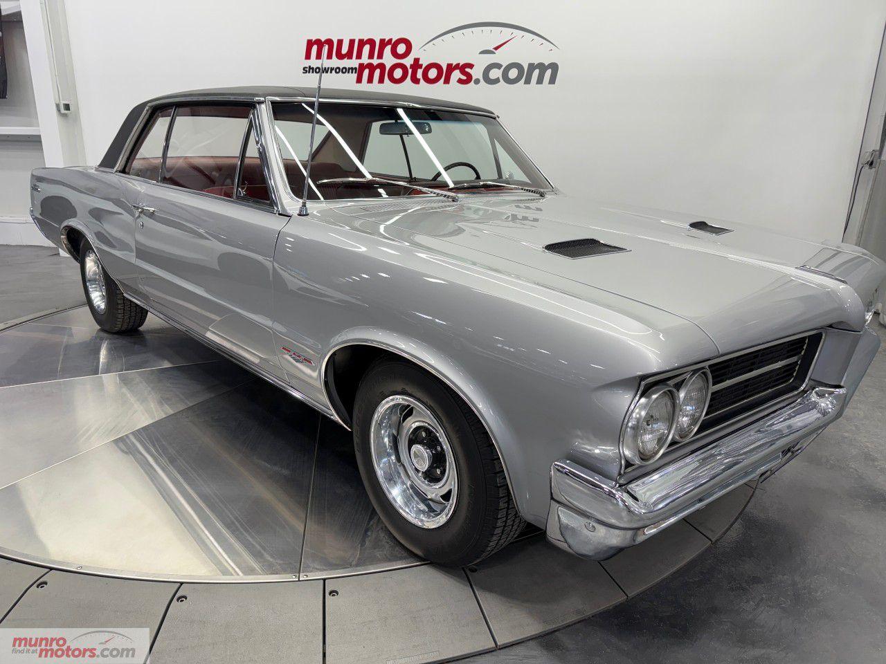 <p>Vehicle Highlights include: Restored GTO, 389 Cubic Inch Engine, Tri-Power Carbs, 4 Speed Manual, 3.23 Rear Gears, Dual Exhaust, Rally Wheels, Power Steering, Power Brakes, & Bucket Seats.</p><p>Step into automotive history with this stunning restored 1964 Pontiac GTO, a true classic that revolutionized the muscle car era. Known as one of the first cars to bring high-performance to the streets, the GTO remains an icon of American automotive engineering. This particular 1964 model, equipped with a powerful 389 Tri-Power V8 engine and a 4-speed manual transmission, is a rare find that combines timeless style, performance, and pedigree.</p><p>The heart of this GTO is its legendary 389 cubic inch V8 engine, topped with the coveted Tri-Power carburetor setup. With three 2-barrel carburetors, this setup boosts power and throttle response, delivering an exhilarating driving experience with around 358 horsepower at your command.</p><p>The 4-speed manual transmission gives you the pure driving experience that enthusiasts crave. This gearbox allows you to feel the connection to the car and truly harness the muscle of the 389 engine. The dual exhaust system delivers that deep, unmistakable muscle car rumble, while the correct</p><p>Pontiac exhaust tips ensure that the cars sound is both authentic and exhilarating.</p><p>The 1964 GTO features the sleek and aggressive styling Pontiac is known for, with clean lines, a wide stance, and a commanding presence on the road. The Pontiac Rally Wheels with beauty rings are mounted on BF Gooderich Tires. The chrome accents, signature grille, and GTO badging are a testament to the performance heritage of this muscle car.</p><p>This GTOs combination of raw power, balanced handling, and a thrilling exhaust note provides a driving experience that is second to none. Whether youre cruising down the highway or taking it to the track, the 1964 GTO delivers thrills at every turn.</p><p>The classic interior features bucket seats, a floor-mounted shifter, and a driver-focused dashboard. Its a no-nonsense cabin that reflects the car's performance roots while providing comfort and style for those long drives.</p><p>Finished in the striking Silvermist Grey exterior with a Medium Red interior, this GTO is a standout example of Pontiacs engineering and style from the golden age of American performance cars</p><p>This is a true example of the original 1964 Pontiac GTO, featuring the rare 389 Tri-Power V8, 4-speed manual transmission with a Hurst shifter, and 3.23 Limited Slip Differential  a combination that is sought after and incredibly rare in the collector world. An added bonus is Power Steering and Power Drum Brakes.</p><p>The Trunk is nicely detailed with Houndstooth trunk mat, fire extinguisher, steel spare rim mounted on Red Line Tire, and factory jack assembly.</p><p>The 1964 Pontiac GTO is considered the car that ignited the muscle car revolution. The limited availability of this exact configuration  especially in pristine condition  makes it an ideal addition to any collection, a car that will continue to appreciate in value.</p><p>With 358 horsepower on tap, the GTO is a testament to Pontiacs engineering prowess. Whether youre looking to add it to your collection or enjoy it on the open road, this car will deliver thrills every time.</p><p>This GTO is in excellent condition, with a beautifully restored body and a mechanically sound engine and transmission. The chrome, brightwork, and glass are in great condition. The interior has been carefully restored and looks/feels fresh, the exterior shines with a deep gloss finish, and the undercarriage is nicely detailed. It drives like a dream, with components working as they should  a true testament to its original build quality and careful restoration.</p><p>Whether you're a seasoned collector or a first-time muscle car buyer, this 1964 Pontiac GTO with its 389 Tri-Power V8 and 4-speed manual is an absolute must-see. Don't miss the chance to own a part of automotive history. Come on down to Munro Motors & see this one for yourself, its in stock. We will look forward to seeing you real soon!</p><p>True Mileage Unknown</p><p></p><p></p><p><span style=color:rgb( 51 , 51 , 51 )>Yes we take trade in vehicles.</span></p><p><span style=color:rgb( 51 , 51 , 51 )>Check us out on youtube: </span><a href=https://www.youtube.com/watch?v=SiWMyyl2NRs rel=nofollow>https://www.youtube.com/watch?v=SiWMyyl2NRs</a></p><p><span style=color:rgb( 51 , 51 , 51 )>Like us on Facebook: </span><a href=https://www.facebook.com/munromotors/ rel=nofollow>https://www.facebook.com/munromotors/</a></p><p><span style=color:rgb( 51 , 51 , 51 )>We are located in Brantford, Ontario; Telephone City and the hometown of hockey legend Wayne Gretzky. Formerly located in St. George, Ontario for ten years, we are still east of London, south of Cambridge, and west of Hamilton.</span></p><p><span style=color:rgb( 51 , 51 , 51 )>In order to get our customers to come here, we have to have great prices and then when you get here, we have to have a great car in order to earn your business.</span></p><p><span style=color:rgb( 51 , 51 , 51 )>Our business hours are Monday to Friday 10am to 5pm. We are closed on Saturdays and Sundays.</span></p><p><span style=color:rgb( 51 , 51 , 51 )>At Munro Motors, we find unique vehicles and post our entire stock online in order to ensure that our vehicles find their happy home.</span></p><p><span style=color:rgb( 51 , 51 , 51 )>To ensure our customers can get what they've always wanted, we offer financing services through TD Auto Finance, Desjardins, CIBC Auto Finance and Independent Leasing Companies on vehicles that are less than ten model years old and boats that are less than twenty-five model years old.</span></p><p><span style=color:rgb( 51 , 51 , 51 )>We also offer warranty products through Lubrico and GVC warranties to ensure that your mechanical baby stays in tip-top condition.</span></p><p><span style=color:rgb( 51 , 51 , 51 )>Because of our customer focused service we have been delivering vehicles to Switzerland, Finland, Rotterdam, Emo, Thunder Bay, Kapuskasing, Halifax, Sudbury, Sault Ste. Marie, Cornwall, Fort Francis, Kelowna, Montréal, Saskatchewan, Virginia, Newfoundland, Edmonton, Ottawa, Fredericton and Winnipeg, as well as Cambridge, Kitchener, Waterloo, Barrie, Windsor, London, Pickering, Peterborough, Oshawa, Sante Fe New Mexico, Blind River, the Greater Toronto Area, and even so far as the Czech Republic!</span></p><p><span style=color:rgb( 51 , 51 , 51 )>All of our vehicles are hand-picked by the very knowledgeable owner, Andy Munro, who has been connecting people to their dreams for many years.</span></p><p><a href=http://Munromotors.com rel=nofollow><span style=color:rgb( 51 , 51 , 51 )>Munromotors.com</span></a></p><p><span style=color:rgb( 51 , 51 , 51 )>Email: sales@munromotors.com</span></p><p><span style=color:rgb( 51 , 51 , 51 )>Most of our vehicles are already reconditioned, saftied, etested and ready to drive home with you.</span></p><p><span style=color:rgb( 51 , 51 , 51 )>Delivery is available. Ask for details</span></p><p><span style=color:rgb( 51 , 51 , 51 )>All prices are subject to HST and licensing, no hidden fees.</span></p><p><span style=color:rgb( 51 , 51 , 51 )>Financing is available for good credit and bruised credit. OAC as low as 7.99% for well qualified applicants. Ask us for details.</span></p>