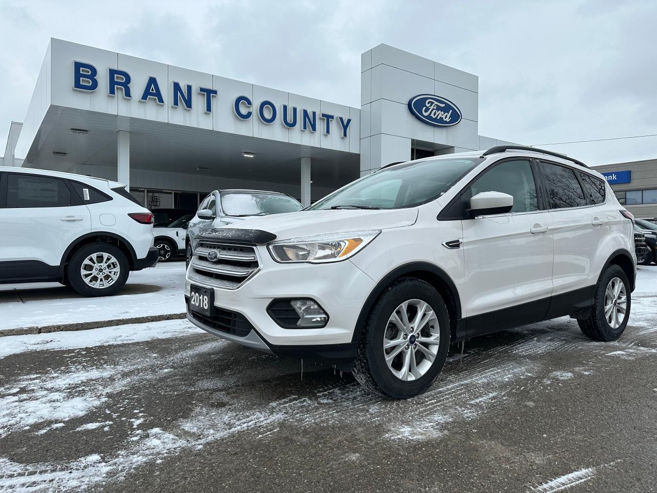 <p>Looking for a reliable and stylish SUV that wont break the bank? Look no further than this 2018 Ford Escape SE at Brant County Ford! This white beauty boasts a 1.5L 4-cylinder engine, a smooth automatic transmission, and front-wheel drive for efficient handling on the road. With 158,118km on the odometer, this Escape is ready to take on your next adventure.</p><p>Inside, youll find a comfortable and spacious interior with features that make every journey enjoyable. Stay cool with the air conditioning, and enjoy the convenience of keyless entry and power windows. The Escape also comes equipped with safety features like anti-lock brakes, driver and passenger airbags, and side airbags, giving you peace of mind on every drive.</p><p>Here are 5 of the features that make this Escape stand out:</p><ul><li><strong>Automatic Headlights:</strong> Never worry about forgetting to turn your headlights on again with this convenient feature.</li><li><strong>Heated Mirrors:</strong> Stay safe and clear-sighted in all conditions with the heated mirrors that keep your view unobstructed.</li><li><strong>Power Door Locks:</strong> Enjoy the ease of locking and unlocking your doors with the push of a button.</li><li><strong>Power Mirrors:</strong> Adjust your mirrors to your exact preference with the power adjustment feature.</li><li><strong>Rear Window Defroster:</strong> Say goodbye to icy mornings with the rear window defroster that keeps you safe and clear.</li></ul><p>Visit Brant County Ford today to see this impressive 2018 Ford Escape in person and experience its sleek style and impressive features for yourself!</p><p class=MsoNoSpacing>Price includes safety.<span style=mso-spacerun: yes;>  </span>We are a full disclosure dealership - ask to see this vehicles CarFax report.</p><p class=MsoNoSpacing><span style=mso-spacerun: yes;> </span>Brant County Ford is a family-owned dealership and has been a proud member of the Brantford community for over 40 years!</p><p class=MsoNoSpacing>** See dealer for details.</p><p class=MsoNoSpacing>*Please note all prices are plus HST and Licensing.</p><p class=MsoNoSpacing>* Prices in Ontario, Alberta and British Columbia include OMVIC/AMVIC fee (where applicable), accessories, other dealer installed options, administration and other retailer charges.</p><p class=MsoNoSpacing> </p><p class=MsoNoSpacing>All prices are in Canadian dollars (unless otherwise indicated). Retailers are free to set individual prices.</p>