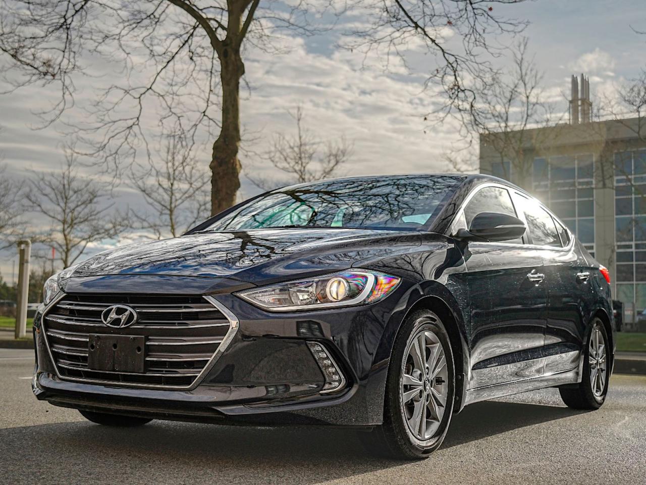 Experience the Perfect Blend of Luxury and Performance with the Pre-Owned 2017 Hyundai Elantra Limited!Step into the drivers seat and indulge in the sophistication and versatility of the 2017 Hyundai Elantra Limited. This Blue beauty is loaded with features that will make each journey a memorable one. Heres why you should consider this exceptional vehicle:Luxurious Comfort: Sink into the plush leather seats and find your perfect driving position with the driver adjustable lumbar and seat memory options. The heated front and rear seats, along with the heated steering wheel, ensure youll stay cozy even during the coldest days. Plus, the multi-zone climate control system keeps everyone comfortable, no matter their preference.Advanced Technology: Seamlessly connect to your favorite music and apps with the integrated MP3 capability, Bluetooth connection, and Smart Device Integration. The premium sound system offers unparalleled audio quality, while the navigation system ensures youll never lose your way again. The hands-free liftgate adds convenience to your daily routine.Sophisticated Design: The Blue exterior is sleek and stylish, showcasing your impeccable taste. The generic sun/moonroof floods the cabin with natural light, giving it an airy and inviting feel. The integrated turn signal mirrors add a touch of elegance while enhancing your safety on the road.Safety First: Drive with confidence knowing that this Elantra Limited comes equipped with advanced safety features like cross-traffic alert, blind spot monitor, back-up camera, and stability control. The rear parking aid and front and rear head airbags ensure you and your passengers are protected.Exceptional Performance: The 4-cylinder engine, front-wheel drive, and smooth 6-speed automatic transmission with dual shift mode provide an exhilarating driving experience. Cruise control and adjustable steering wheel make every mile effortless, while the traction control ensures you stay in control even on slippery terrain.Unbeatable Value: The Hyundai Elantra Limited offers exceptional value for your money. With low mileage, a proven track record for reliability, and a thorough inspection, you can be confident in your investment.Dont miss out on the opportunity to own this stunning 2017 Hyundai Elantra Limited. Contact us today to schedule a test drive and see how this incredible vehicle can enhance your daily commute and elevate your driving experience.