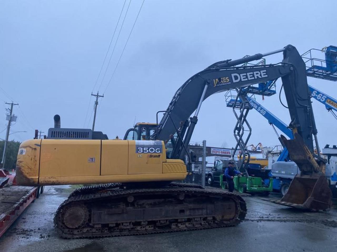 2014 John Deere 350G LC Excavator Diesel, 6 cylinder, 	13462 hours, yellow exterior, black interior, cloth. Engine model PowerTech PSX 9.0 L,Operating Weight 76557.8lb, Cool-on-demand hydraulic-driven, suction-type fan with remote-mounted drive,
The John Deere 350G LC has a Final Tier 4-certified diesel engine with a PowerTech PSX 9.0 L model and 299.1 horsepower. It also has a diesel particulate filter and diesel oxidation catalyst to reduce particulate matter,The 350G LC has three productivity modes, including a high-productivity mode for moving more material,The excavator has a new hood design, expanded glass, narrow front cab posts, overhead glass, and multiple mirrors.
Shipping length: 37.18 ft
Shipping height: 11.39 ft
Max cutting height: 32.78 ft
Max loading height: 22.77 ft
Max reach along ground: 34 ft
Max digging depth: 22.45 ft
Ground clearance: 0.17 ft
Height to top of cab: 10.31 ft
Width to outside of tracks: 11.13 ft
All measurements and specifications are considered to be accurate but not guaranteed  $59,500.00 plus $375 processing fee, $59,875.00 total payment obligation before taxes.  Listing report, warranty, contract commitment cancellation fee, financing available on approved credit (some limitations and exceptions may apply). All above specifications and information is considered to be accurate but is not guaranteed and no opinion or advice is given as to whether this item should be purchased. We do not allow test drives due to theft, fraud, acts of vandalism and undetectable impaired driving. Instead we provide the following benefits: Complimentary Warranty (with options to extend), Limited Money Back Satisfaction Guarantee on Fully Completed Contracts, Contract Commitment Cancellation, and an Open-Ended Sell-Back Option. Ask seller for details or call 604-522-REPO(7376) to confirm listing availability.