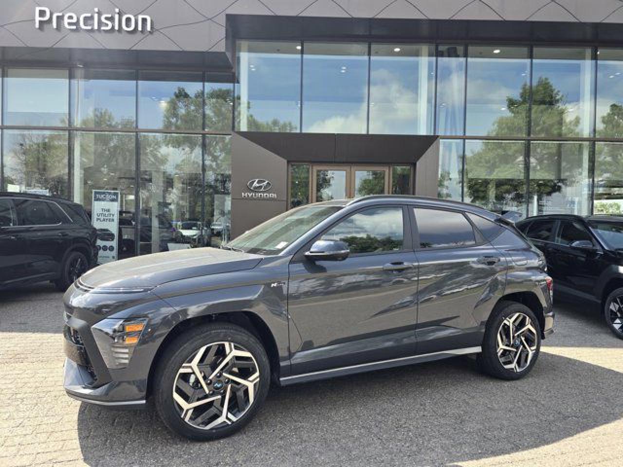 *2025 Hyundai Kona N-Line* Unleash bold style and dynamic performance with the *2025 Hyundai Kona N-Line*, designed for those who crave excitement and cutting-edge technology in their daily drive.    * *Key Features at a Glance*:      * *Performance & Handling*: Sporty All-Wheel Drive capability for confident driving in any condition.     * *Comfort & Convenience*: Heated Front Seats, Heated Steering Wheel, and a driver-centric cabin for maximum comfort.     * *Advanced Safety*: Blind-Spot Monitor, Lane Departure Assist, Adaptive Cruise Control, and Forward Collision Avoidance to keep you safe on the road.     * *Technology*: Bluelink connectivity, Wireless Charging, Smart Park Assist (Self-Parking), and an advanced Navigation system to enhance every journey.     * *Sporty Design*: Sleek N-Line exterior with an aerodynamic spoiler and bold accents for a standout look.    * *Warranty*: Hyundais *5-Year/100,000-Kilometer Warranty* ensures confidence with every drive.  *Precision Hyundai Advantages* At Precision Hyundai, all advertised pricing is *all-inclusive*---just add GST. This includes the Alberta Roads Package, Hood Fender & Mirror 3M, PDI, Security Registration, Tire Levy, and AMVIC Fee. *Why Choose Precision Hyundai?* Make the Precision Decision and visit *Western Canadas Best Hyundai Dealership*, proudly serving customers for over 40 years. If theres a specific feature youd like to learn more about, our expert team is here to help! *Get Ready to Turn Heads. Experience the 2025 Hyundai Kona N-Line Today!*