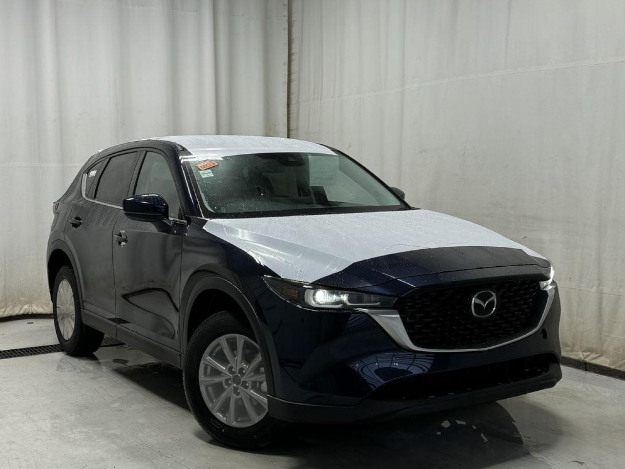 <p>NEW 2025 CX-5 GS AWD. Bluetooth, Skyactiv-G 2.5 L (Inline-4). Backup Cam, Available NAV, Leatherette/Suede Heated Seats, Type-C USB Input, Keyless Remote Entry, Power Trunk, Adaptive Cruise Control, Heated Steering Wheel, Wiper Blade De-Icer, Auto Dual-Zone Climate Control, Rear Air Vents, Auto Rain-Sensing Wipers, Electronic Parking Brake, Heated Mirrors, 17 Silver Metallic Alloy Wheels</p>  <p>Includes:</p> <p>i-ACTIVSENSE + Safety Features (Smart City Brake Support-Front, Rear Cross Traffic Alert, Mazda Radar Cruise Control With Stop & Go, Distance Recognition Support System, Lane-Keep Assist System, Lane Departure Warning System, Advanced Blind Spot Monitoring)</p>  <p>A joy to drive, our 2025 Mazda CX-5 GS AWD radiates refined style in Deep Crystal Blue Mica! Motivated by a 2.5 Liter 4 Cylinder that delivers 187hp tethered to a paddle-shifted 6 Speed Automatic transmission. You can put that strength to good use with the added traction of torque vectoring, and this All Wheel Drive SUV returns nearly approximately 7.8L/100km on the highway. Our CX-5 also has an expressive design with bold details like 17-inch alloy wheels, a rear roof spoiler, and bright-tipped dual exhaust outlets.</p>  <p>Our GS cabin is no ordinary interior. Its tailor-made for better travel with heated leatherette/suede power front seats, a leather-wrapped steering wheel, automatic climate control, pushbutton ignition, and keyless access. Mazda makes connecting easy by providing a 10.25-inch central display, a multifunction Commander controller, Apple CarPlay/Android Auto, Bluetooth, voice control, and six-speaker audio. The versatile rear cargo space adds adventure-friendly functionality.</p>  <p>Safety is a high priority for Mazda, which helps protect you and your loved ones with automatic emergency braking, adaptive cruise control, a rearview camera, lane-keeping assistance, blind-spot monitoring, and other intelligent technologies. With all that, our CX-5 GS is here to transcend the ordinary! Save this page, Come in for a Qualified Test Drive. We Know You Will Enjoy Your Test Drive Towards Ownership!</p>  <p>Call 587-409-5859 for more info or to schedule an appointment! Listed Pricing is valid for 72 hours. Financing is available, please see dealer for term availability and interest rates. AMVIC Licensed Business.</p>