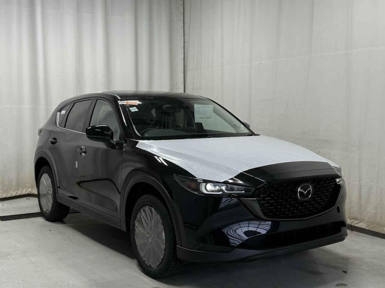 <p>NEW 2025 CX-5 Kuro AWD. Bluetooth, Skyactiv-G 2.5 L (Inline-4) Cylinder Deactivation. Backup Cam, Available NAVm Memory Seat, Heated Seats, Keyless Remote Entry, Power Trunk, Adaptive Cruise Control, Heated Steering Wheel, Wiper Blade De-Icer, Auto Dual-Zone Climate Control, Rear Air Vents, Auto Rain-Sensing Wipers, Electronic Parking Brake, Heated Mirrors, 19 Black Metallic Alloy Wheels, Signature Wing Grille, Exterior Mirrors In Brilliant Black</p>  <p>Includes:</p> <p>i-ACTIVSENSE + Safety Features (Smart City Brake Support-Front, Rear Cross Traffic Alert, Mazda Radar Cruise Control With Stop & Go, Distance Recognition Support System, Lane-Keep Assist System, Lane Departure Warning System, Advanced Blind Spot Monitoring)</p>  <p>A joy to drive, our 2025 Mazda CX-5 Kuro AWD radiates refined style in Jet Black Mica! Motivated by a 2.5 Liter 4 Cylinder that delivers 187hp tethered to a paddle-shifted 6 Speed Automatic transmission. You can put that strength to good use with the added traction of torque vectoring, and this All Wheel Drive SUV returns nearly approximately 7.8L/100km on the highway. Our CX-5 also has an expressive design with bold details like 17-inch alloy wheels, a rear roof spoiler, and bright-tipped dual exhaust outlets.</p>  <p>Our Kuro cabin is no ordinary interior. Its tailor-made for better travel with heated leather power front seats, a leather-wrapped steering wheel, automatic climate control, pushbutton ignition, and keyless access. Mazda makes connecting easy by providing a 10.25-inch central display, a multifunction Commander controller, Apple CarPlay/Android Auto, Bluetooth, voice control, and six-speaker audio. The versatile rear cargo space adds adventure-friendly functionality.</p>  <p>Safety is a high priority for Mazda, which helps protect you and your loved ones with automatic emergency braking, adaptive cruise control, a rearview camera, lane-keeping assistance, blind-spot monitoring, and other intelligent technologies. With all that, our CX-5 Kuro is here to transcend the ordinary!!</p>  <p>Call 587-409-5859 for more info or to schedule an appointment! Listed Pricing is valid for 72 hours. Financing is available, please see dealer for term availability and interest rates. AMVIC Licensed Business.</p>