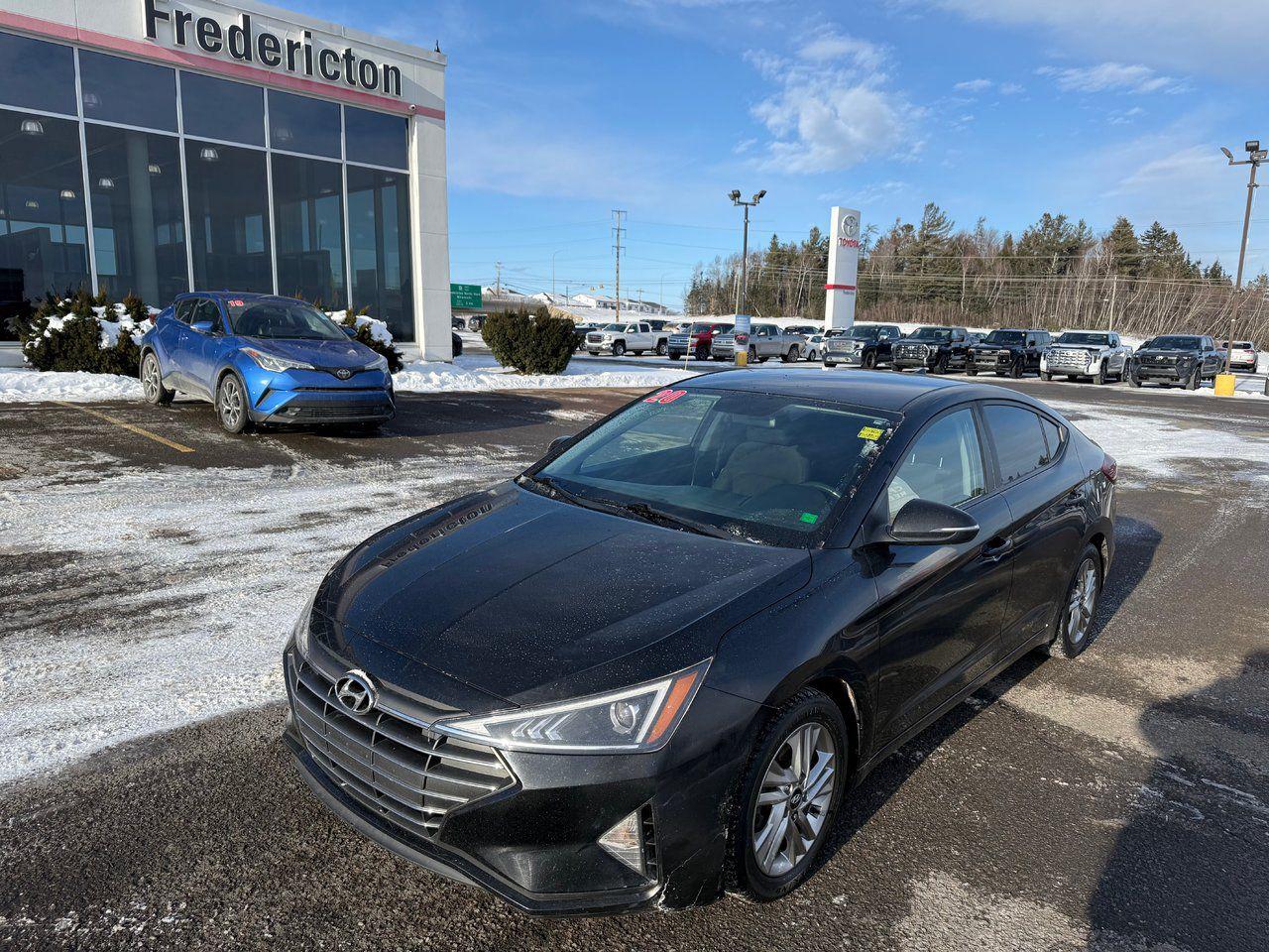 The 2020 Hyundai Elantra is a compact sedan offering advanced safety and comfort features. It includes multiple airbags, ABS, traction control, blind spot monitoring, and cross-traffic alert. The cabin has A/C, cloth seats, heated front seats, and a leather-wrapped steering wheel. Tech features include Bluetooth, MP3 capability, a back-up camera, and steering wheel audio controls. Additional conveniences include keyless entry, power windows, power mirrors, and a heated steering wheel. With its stylish design, spacious interior, and safety tech, the Elantra delivers a smooth and secure driving experience.

<span>Why choose to buy from Fredericton Toyota? When you buy from us, you’re not just a customer — you’re part of the family, and we’re committed to providing exceptional service every step of the way.</span>