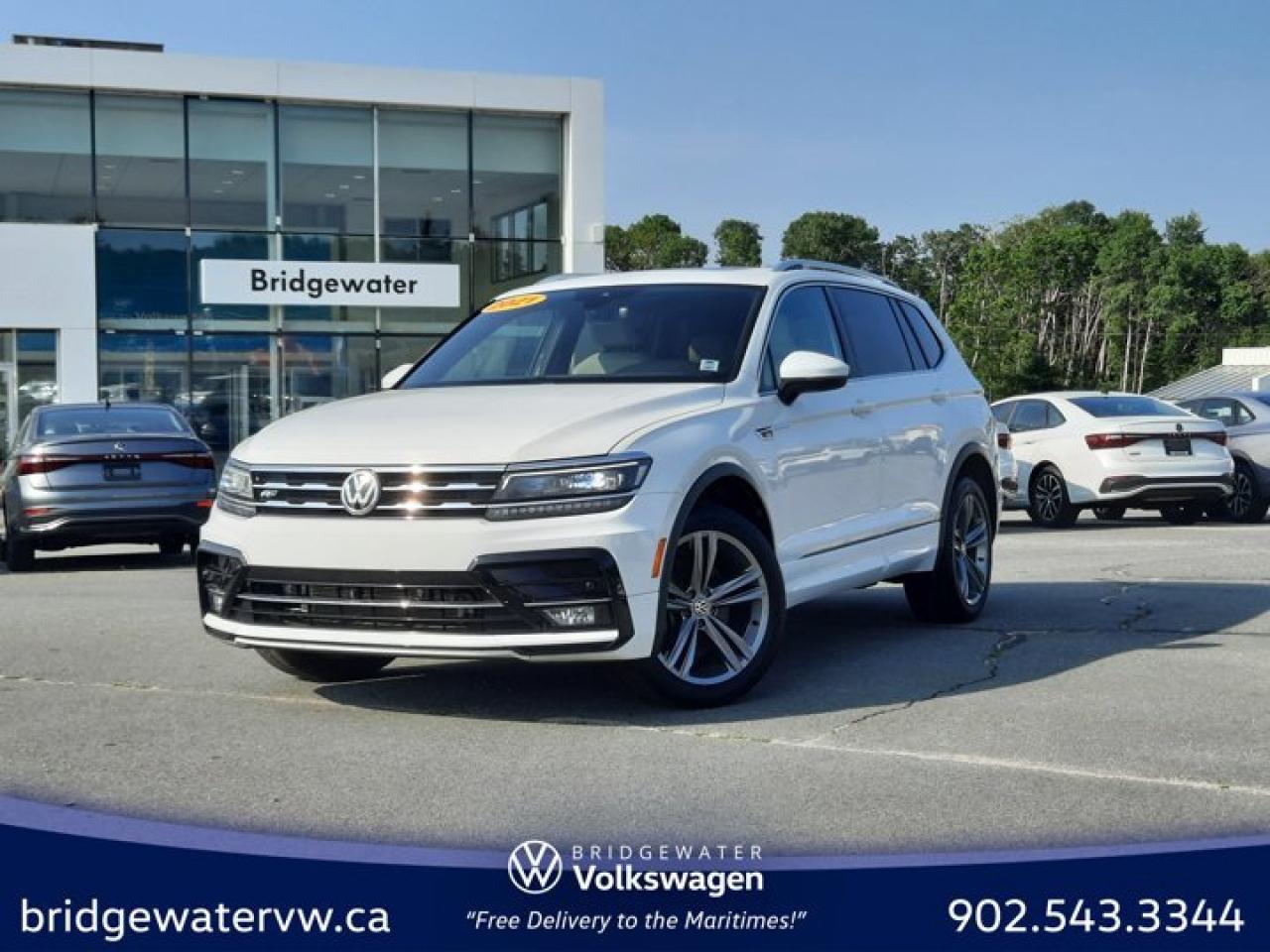 New Price! Pure White 2021 Volkswagen Tiguan Highline R-LINE | 4Motion | Apple CarPlay | Android Auto | AWD 8-Speed Automatic with Tiptronic 2.0L TSI Bridgewater Volkswagen, Located in Bridgewater Nova Scotia.AWD, 3.33 Axle Ratio, 4-Wheel Disc Brakes, 9 Speakers, ABS brakes, Air Conditioning, Alloy wheels, Aluminum Door Sills w/R-Line Logo, AM/FM radio: SiriusXM, Auto High-beam Headlights, Auto-dimming Rear-View mirror, Automatic temperature control, Black Headliner, Brake assist, Brushed Stainless Steel Pedals in Aluminum Look, Bumpers: body-colour, Compass, Delay-off headlights, Driver door bin, Driver vanity mirror, Dual front impact airbags, Dual front side impact airbags, Electronic Stability Control, Four wheel independent suspension, Front anti-roll bar, Front Bucket Seats, Front dual zone A/C, Front fog lights, Front reading lights, Fully automatic headlights, Heated door mirrors, Heated front seats, Heated Front Sport Seats, Heated steering wheel, Illuminated entry, Leather Seating Surfaces, Leather Shift Knob, Low tire pressure warning, Memory seat, Navigation System, Occupant sensing airbag, Outside temperature display, Overhead airbag, Overhead console, Panic alarm, Passenger door bin, Passenger vanity mirror, Power door mirrors, Power driver seat, Power Liftgate, Power moonroof, Power steering, Power windows, R-Line Exterior Design, R-Line Leather-Wrapped Heated Sport Steering Wheel, R-Line Package, Radio data system, Radio: Fender Premium Audio System, Rain sensing wipers, Rear anti-roll bar, Rear reading lights, Rear window defroster, Rear window wiper, Remote keyless entry, Roof rack: rails only, Security system, Speed control, Speed-sensing steering, Split folding rear seat, Spoiler, Standard Suspension, Steering wheel mounted audio controls, Tachometer, Telescoping steering wheel, Tilt steering wheel, Traction control, Trip computer, Turn signal indicator mirrors, Variably intermittent wipers, Wheels: 7J x 18 Nizza Alloy, Wheels: 8.5J x 19 Trenton Alloy.Volkswagen Certified Details:* Finance rates from 4.69%. Rates valid until June 30, 2025* A completed 112-point inspection plus mechanical and appearance reconditioning assessment performed by a Volkswagen factory-trained technician* Any remaining new-vehicle limited warranty. Certified Pre-Owned vehicles are eligible for extended warranty coverage, giving you greater peace of mind* Prepaid Maintenance is now available for Certified Pre-Owned Volkswagens. Lock in your maintenance fees by choosing between a 2- or 3-year plan. Vehicles up to 7 years of age are eligible for the purchase of our Prepaid Maintenance plans regardless of mileage. A 3-month SiriusXM all-access trial subscription / Recent college, CEGEP or university Graduates can get a $500 rebate / CARFAX Vehicle History Report. A 3-month SiriusXM all-access trial subscription* A 6-month subscription to Volkswagen 24-hour roadside assistanceReviews:* Owners and experts alike almost universally count the Tiguans ride quality, highway manners, interior, and overall easy-to-drive character among its most valuable assets. The central touchscreen infotainment system and all-digital instrument cluster are commonly listed as feature favourites, as they add a high-tech flair to the driving environment. Source: autoTRADER.ca