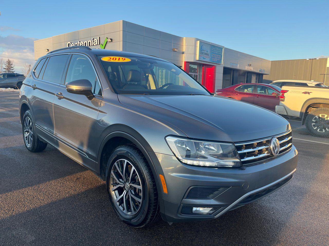 <span>Theres always something typically Germanic about the way a Volkswagen drives, and this all-wheel-drive 2019 Tiguan is no exception. Proper steering weight, a solid feel on the highway, and very stable handling are Tiguan hallmarks. This 2019 Volkswagen Tiguan Comfortline 4Motion offers a huge amount of flexible SUV space – the wheelbase is 27 centimetres longer than the old Tiguan, so theres <em>way</em> more room inside. </span>




<span>The standard equipment list is long. It starts with Apple CarPlay/Android Auto, LED lighting, rearview camera, and stop/start technology so you save money in town driving. Theres also an 8-way power drivers seat, blind spot monitoring with rear cross traffic alert, a big 8-inch touchscreen linked to 8-speaker audio, heated front seats, proximity access with pushbutton start, rain-sensing wipers, satellite radio compatibility, and a panoramic sunroof. There are 17-inch Tulsa wheels, dual-zone automatic climate control, fog lights, heated front seats, an auto-dimming rearview mirror, an 8-way power drivers seat, and satellite radio compatibility.</span>




<span style=font-weight: 400;>Thank you for your interest in this vehicle. Its located at Centennial Nissan, 30 Nicholas Lane, Charlottetown, PEI. We look forward to hearing from you - call us at 1-902-892-6577.</span>