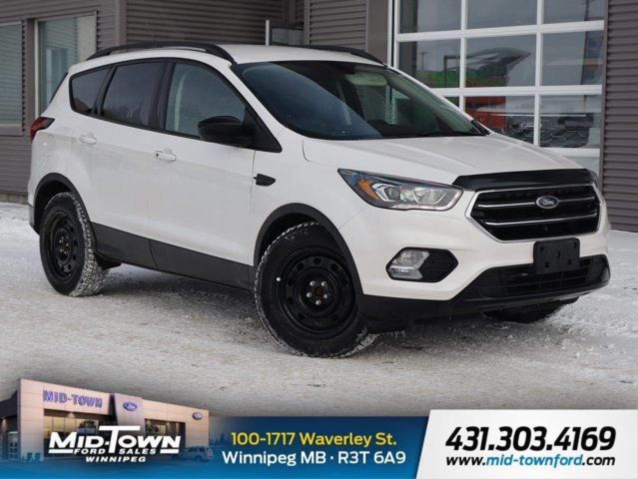 Recent Arrival!<br /><br />| Local Trade, | Non Smoker, 4WD, 3.51 Axle Ratio, 4-Wheel Disc Brakes, 6 Speakers, ABS brakes, Air Conditioning, Alloy wheels, AM/FM radio: SiriusXM, AppLink/Apple CarPlay and Android Auto, Automatic temperature control, Black Beltline Moulding, Black Roof-Rack Side Rails, BLIS Blind Spot Information System, Block heater, Brake assist, Bumpers: body-colour, Compass, Delay-off headlights, Driver door bin, Driver vanity mirror, Dual front impact airbags, Dual front side impact airbags, Electronic Stability Control, Emergency communication system: SYNC 3 911 Assist, Equipment Group 200A, Exterior Parking Camera Rear, Four wheel independent suspension, Front & Rear Gloss Black-Painted Skid Plates, Front anti-roll bar, Front Bucket Seats, Front dual zone A/C, Front fog lights, Front reading lights, Fully automatic headlights, Gloss Black-Painted Sideview Mirror Caps, Gloss Black-Painted Upper Grille Bars & Plinth, Halogen Projector Headlamps w/Black Bezels, Heated door mirrors, Heated front seats, Heated Partial Leather Groove/Salerno Bucket Seats, Heated Unique Cloth Front Bucket Seats, Illuminated entry, Knee airbag, Leather-Wrapped Gear Shift Knob, Leather-Wrapped Steering Wheel, Low tire pressure warning, Navigation System, Occupant sensing airbag, Outside temperature display, Overhead airbag, Overhead console, Panic alarm, Passenger door bin, Passenger vanity mirror, Power door mirrors, Power driver seat, Power steering, Power windows, Radio data system, Radio: AM/FM/MP3 Capable, Rear anti-roll bar, Rear window defroster, Rear window wiper, Remote keyless entry, SE Sport Appearance Package, Security system, Speed control, Speed-sensing steering, Split folding rear seat, Steering wheel mounted audio controls, SYNC 3 Communications & Entertainment System, Tachometer, Taillamps w/Black Bezel, Telescoping steering wheel, Tilt steering wheel, Traction control, Trip computer, Variably intermittent wipers, Voice-Activated Touchscreen Navigation System, Wheels: 17 Sparkle Silver-Painted Aluminum, Wheels: 19 Premium Ebony Black-Painted Aluminum.<br /><br />Odometer is 1873 kilometers below market average! White Platinum Clearcoat Metallic 2019 Ford Escape SE 4WD 1.5L EcoBoost 6-Speed Automatic<br /><br /><br />For further information please contact MidTown Ford sales department directly at 204-284-7650. Dealer #9695.