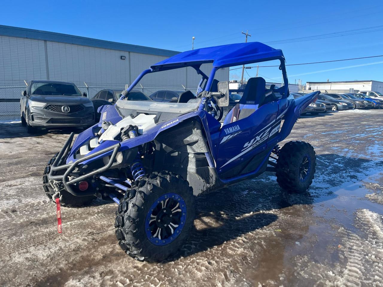 <p data-start=0 data-end=379>The 2018 Yamaha YXZ 1000R EPS SxS is the perfect blend of performance, agility, and rugged durability, designed for thrill-seekers who demand the best from their off-road vehicles. Powered by a 998cc inline triple engine, the YXZ 1000R delivers an incredible 112 horsepower, ensuring you have all the power you need for high-speed runs, steep hill climbs, and challenging trails.</p><p data-start=0 data-end=379>&nbsp;</p><p data-start=381 data-end=819>One of the standout features of the YXZ 1000R is its high-performance 5-speed sequential gearbox, the only one of its kind in a side-by-side. This gearbox gives you direct control over gear changes, delivering faster, smoother shifts and a more connected driving experience. Combined with a Fox 2.5 Podium shock suspension system, this SxS is designed to handle even the toughest terrain with exceptional handling, stability, and comfort.</p><p data-start=381 data-end=819>&nbsp;</p><p data-start=821 data-end=1181>The 2018 YXZ 1000R is equipped with electronic power steering (EPS), offering excellent maneuverability and reducing steering effort, even at low speeds or on rough trails. With 16.2 inches of front and 17.1 inches of rear suspension travel, it glides over rough terrain, rocks, and deep ruts, providing you with the confidence to tackle any challenge head-on.</p><p data-start=821 data-end=1181>&nbsp;</p><p data-start=1183 data-end=1516>The cockpit is built for comfort and performance, featuring high-back bucket seats, a racing-inspired steering wheel, and intuitive controls that allow for precise handling. The 2018 YXZ 1000R is also built with durability in mind, with a heavy-duty chassis and premium components to withstand the most demanding off-road conditions.</p><p data-start=1183 data-end=1516>&nbsp;</p><p data-start=1518 data-end=1764>Whether youre tearing through sand dunes, carving through trails, or pushing your limits on rugged terrain, the 2018 Yamaha YXZ 1000R EPS SxS delivers an unrivaled off-road experience that combines the power, precision, and performance you need.</p><p data-start=1518 data-end=1764>&nbsp;</p><p data-start=1766 data-end=1959 data-is-last-node= data-is-only-node=>Ready to take the 2018 Yamaha YXZ 1000R EPS SxS for a spin? Contact us today to learn more, schedule a test ride, and explore our flexible financing options along with fast nationwide delivery!</p>