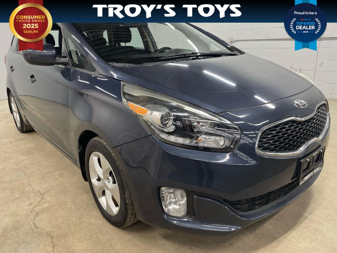 <p>Looking for a reliable and spacious family vehicle? Look no further than this 2015 Kia Rondo LX Value at Troys Toys! This stylish blue wagon boasts a comfortable gray interior and comes equipped with a plethora of features to make your driving experience enjoyable and safe. With only 94,903km on the odometer, this Rondo is ready to take on your next adventure.</p><p>Enjoy the convenience of keyless entry, heated seats for those chilly mornings, and power windows and locks for easy access. Stay connected with the built-in satellite radio and enjoy crisp audio through the CD player and auxiliary input. Safety is paramount, and this Rondo features multiple airbags, anti-lock brakes, stability control, and traction control to keep you and your loved ones safe on the road.</p><p>Here are five sizzling features that set this Rondo apart:</p><ul><li><strong>Heated Front Seats:</strong> Stay cozy and comfortable in even the coldest weather.</li><li><strong>Keyless Entry:</strong> Unlock your car with the push of a button, making your life easier.</li><li><strong>Satellite Radio:</strong> Enjoy a wide variety of music and programming options, keeping you entertained on every drive.</li><li><strong>Stability Control and Traction Control:</strong> Drive with confidence, knowing you have extra safety features keeping you in control.</li><li><strong>Heated Mirrors:</strong> Clear visibility on frosty mornings, ensuring a safe and comfortable driving experience.</li></ul><p>Visit Troys Toys today to take this 2015 Kia Rondo LX Value for a test drive and discover the perfect family car for you.</p><p><em>Powered by AutoIntelligence™ AI</em></p>