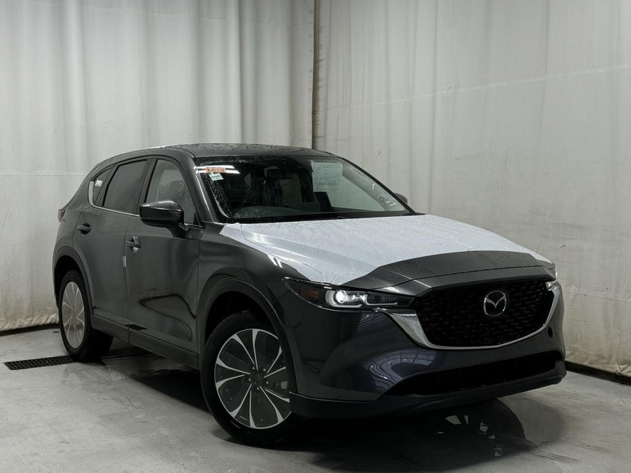 <p>NEW 2025 CX-5 GS Comfort AWD. Bluetooth, Skyactiv-G 2.5 L (Inline-4). Backup Cam, Available NAV, Leatherette Heated Seats, Type-C USB Input, Keyless Remote Entry, Power Trunk, Adaptive Cruise Control, Heated Steering Wheel, Wiper Blade De-Icer, Auto Dual-Zone Climate Control, Rear Air Vents, Auto Rain-Sensing Wipers, Electronic Parking Brake, Heated Mirrors, Alloy Wheels</p>  <p>Includes:</p> <p>(3m h.f.m 18 + awm + cargo tray and a full protection package - UNDERCOAT, PAINT SEALANT, RUST INHIBITOR AND INTERIOR PROTECTION)</p> <p>i-ACTIVSENSE + Safety Features (Smart City Brake Support-Front, Rear Cross Traffic Alert, Mazda Radar Cruise Control With Stop & Go, Distance Recognition Support System, Lane-Keep Assist System, Lane Departure Warning System, Advanced Blind Spot Monitoring)</p>  <p>A joy to drive, our 2025 Mazda CX-5 GS Comfort AWD radiates refined style in Machine Grey Metallic! Motivated by a 2.5 Liter 4 Cylinder that delivers 187hp tethered to a paddle-shifted 6 Speed Automatic transmission. You can put that strength to good use with the added traction of torque vectoring, and this All Wheel Drive SUV returns nearly approximately 7.8L/100km on the highway. Our CX-5 also has an expressive design with bold details like alloy wheels, a rear roof spoiler, and bright-tipped dual exhaust outlets.</p>  <p>Our GS Comfort cabin is no ordinary interior. Its tailor-made for better travel with heated leatherette power front seats, a leather-wrapped steering wheel, automatic climate control, pushbutton ignition, and keyless access. Mazda makes connecting easy by providing a 10.25-inch central display, a multifunction Commander controller, Apple CarPlay/Android Auto, Bluetooth, voice control, and six-speaker audio. The versatile rear cargo space adds adventure-friendly functionality.</p>  <p>Safety is a high priority for Mazda, which helps protect you and your loved ones with automatic emergency braking, adaptive cruise control, a rearview camera, lane-keeping assistance, blind-spot monitoring, and other intelligent technologies. With all that, our CX-5 GS Comfort is here to transcend the ordinary! Save this page, Come in for a Qualified Test Drive. We Know You Will Enjoy Your Test Drive Towards Ownership!</p>  <p>Call 587-409-5859 for more info or to schedule an appointment! Listed Pricing is valid for 72 hours. Financing is available, please see dealer for term availability and interest rates. AMVIC Licensed Business.</p>